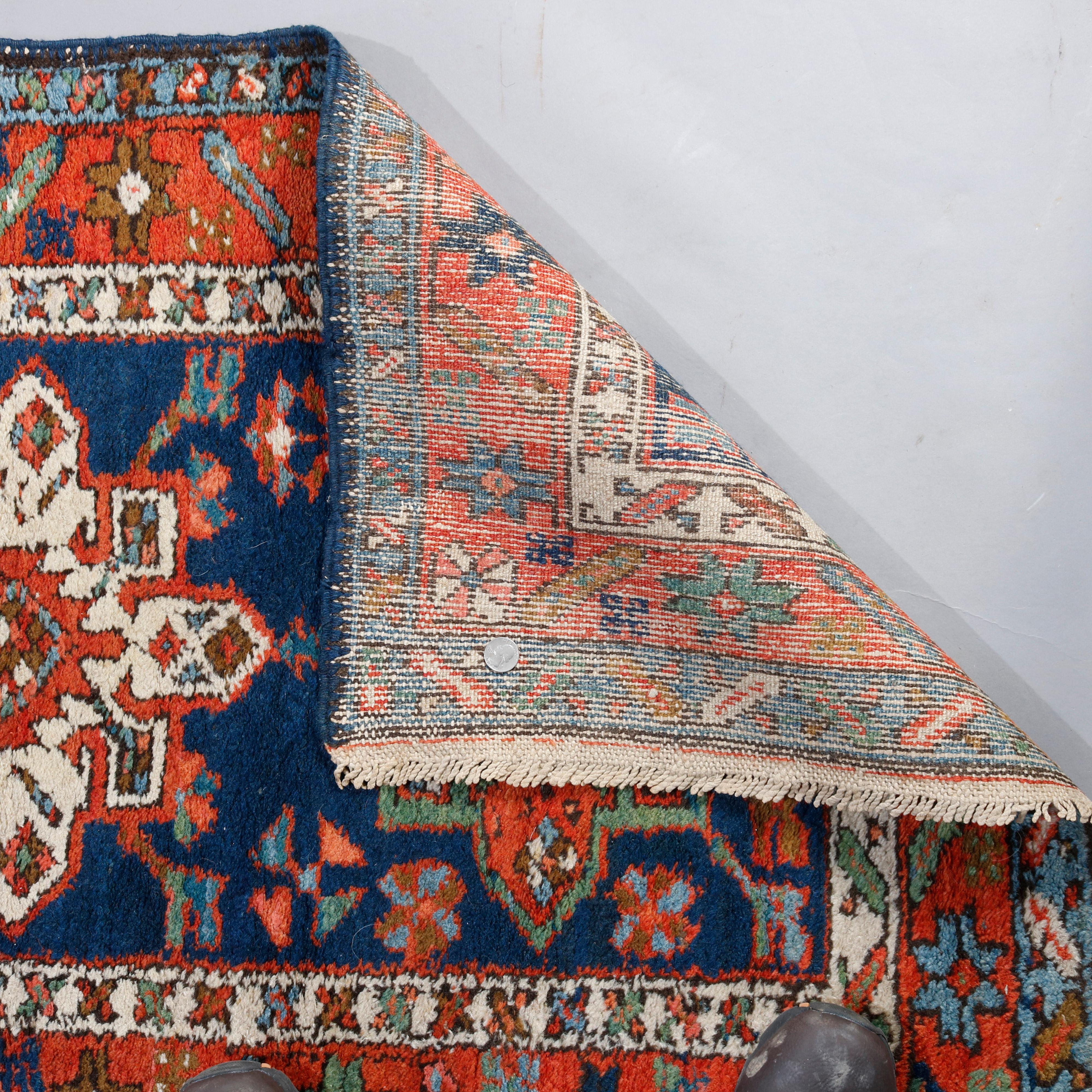 An antique Persian Heriz tribal rug runner offers traditional bold coloring with field ornamented with repeating geometric stylized floral form medallions, circa 1900

***DELIVERY NOTICE – Due to COVID-19 we are employing NO-CONTACT PRACTICES in the