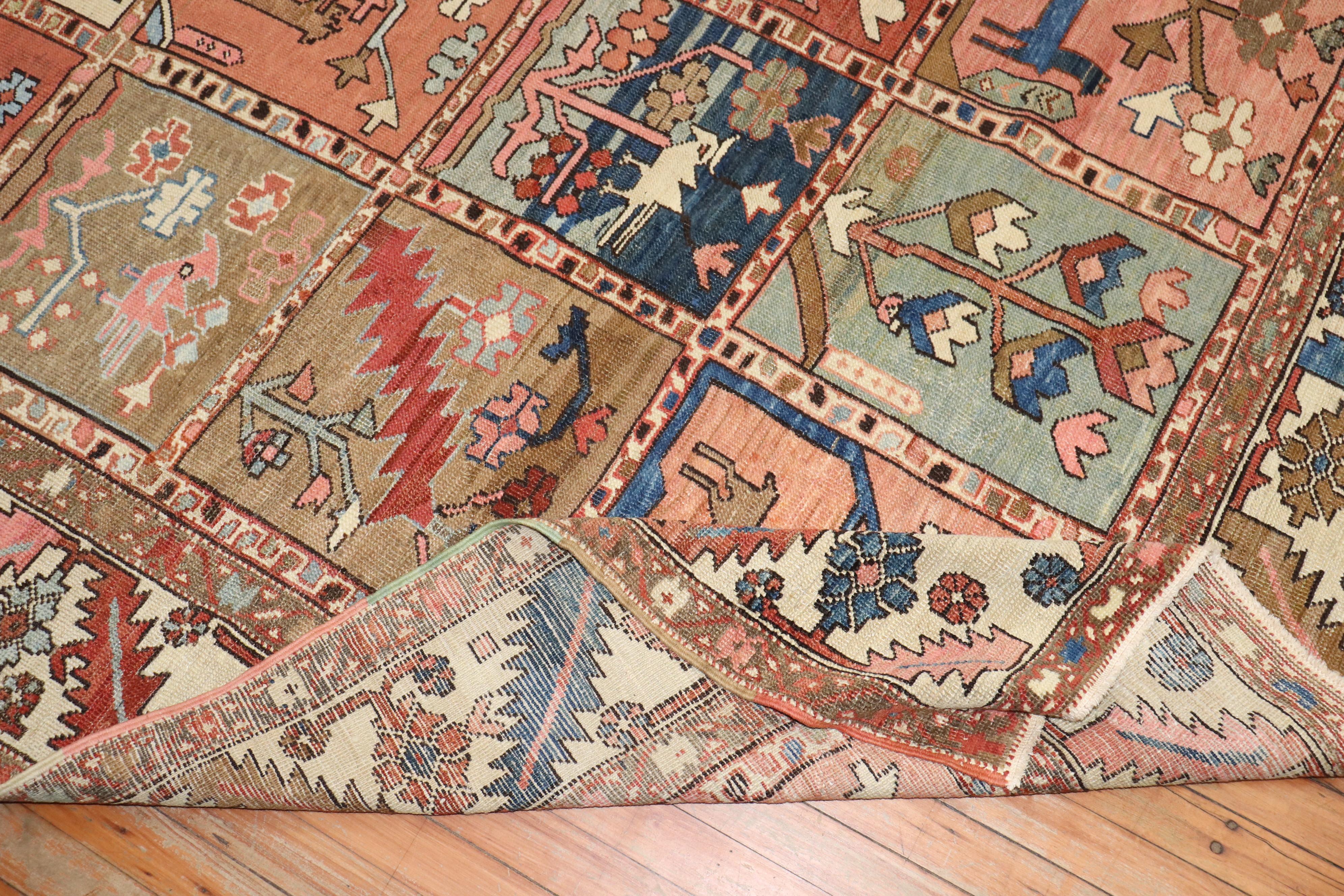 An early 20th Century Persian Heriz rug with a pictorial garden box all over pattern in rustic brown, camel, ivory, pink, and green accent colors

Measures: 9'10'' x 12'7''.

