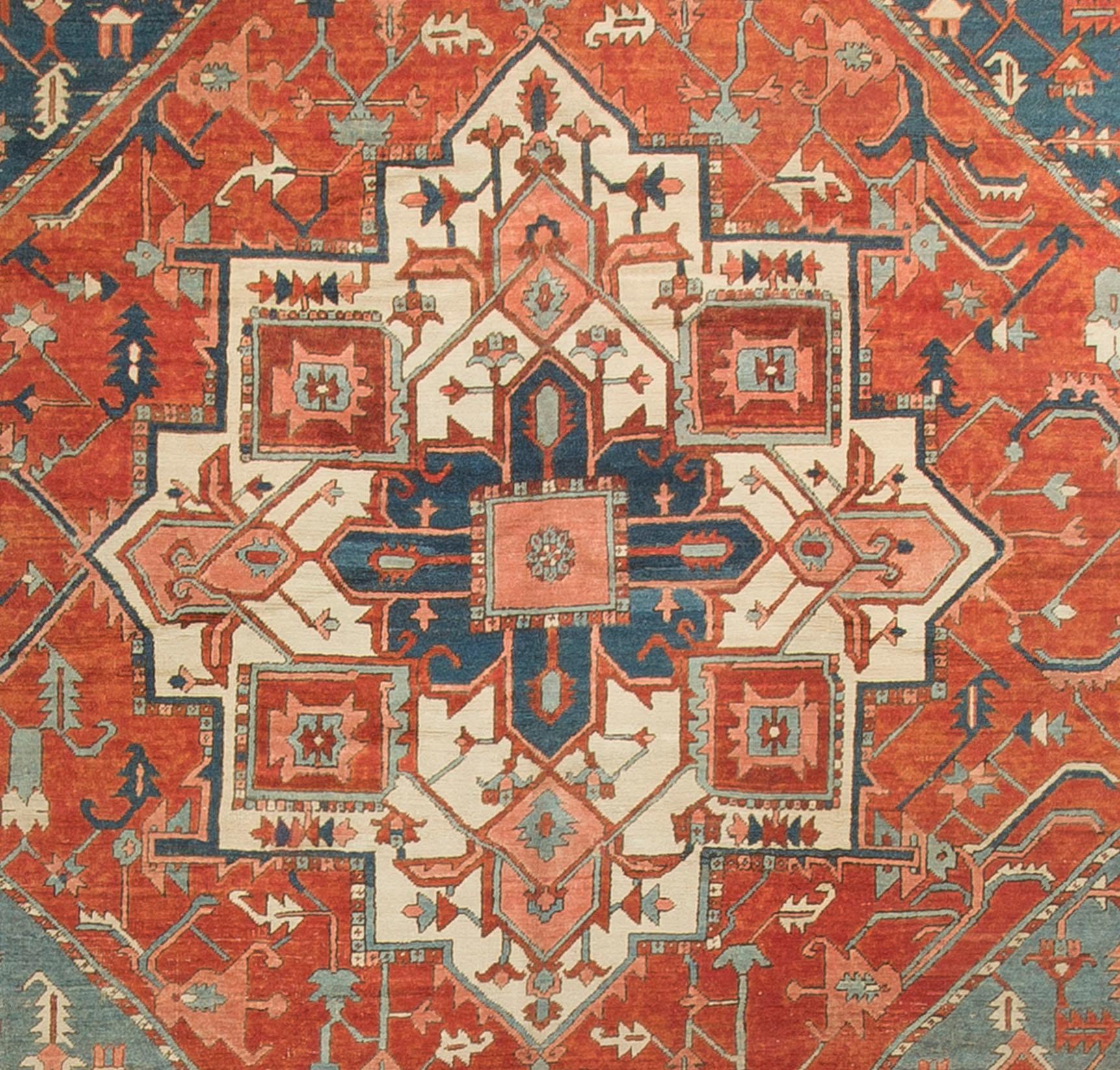Antique Persian Heriz Rug Carpet Circa 1890. An antique Persian Heriz rug, circa 1890. The central medallion enclosed within a brick colored field with the four corner spandrels showing an abrash or natural color change between dark and light blues.