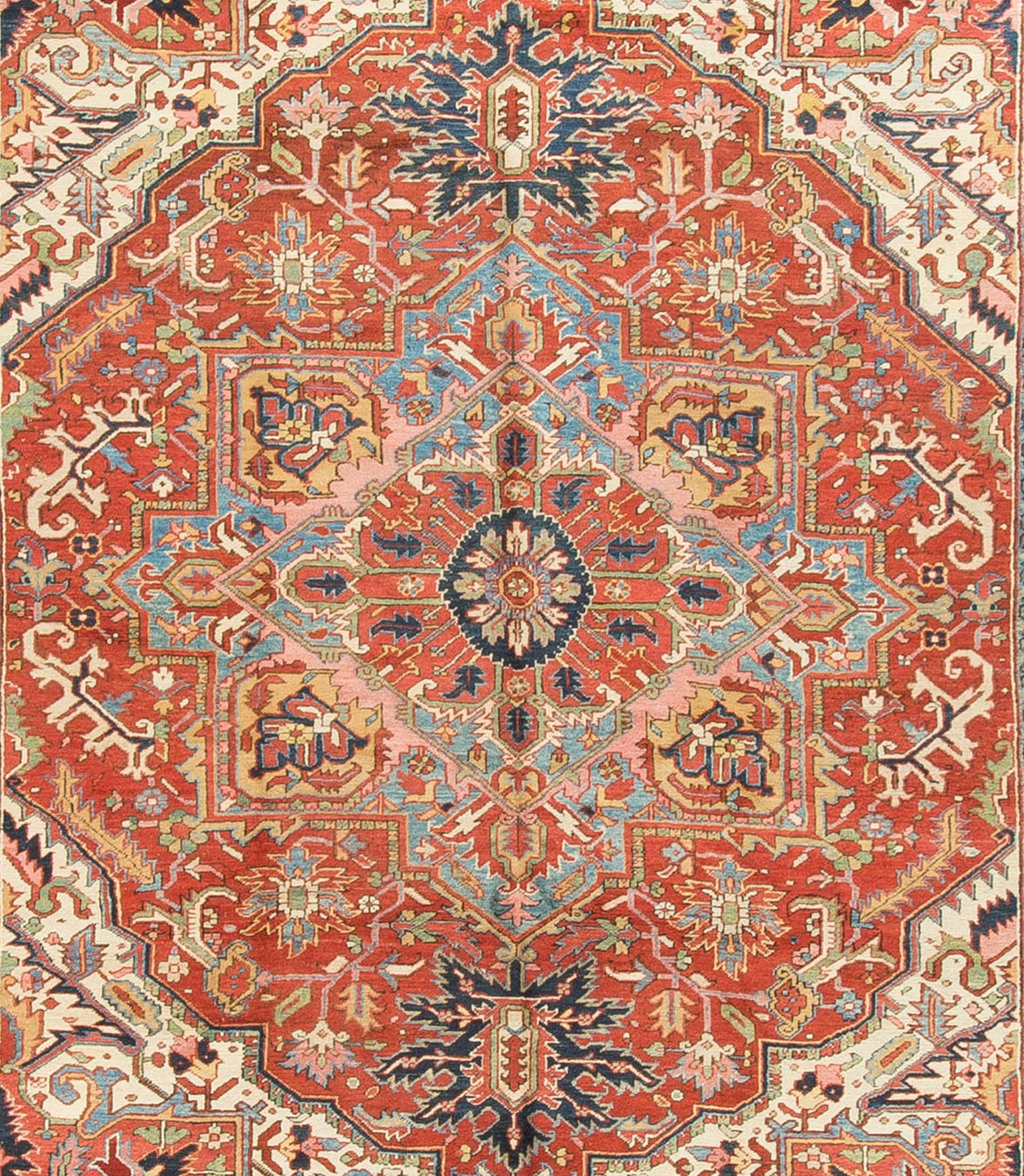 Antique Persian Heriz rug, circa 1900, measures: 9'4 x 11'7. This wonderful antique Heriz rug has a light and easy flow to the design and color scheme. The combination of the soft blue in the center surrounded by reds and them all enclosed in ivory