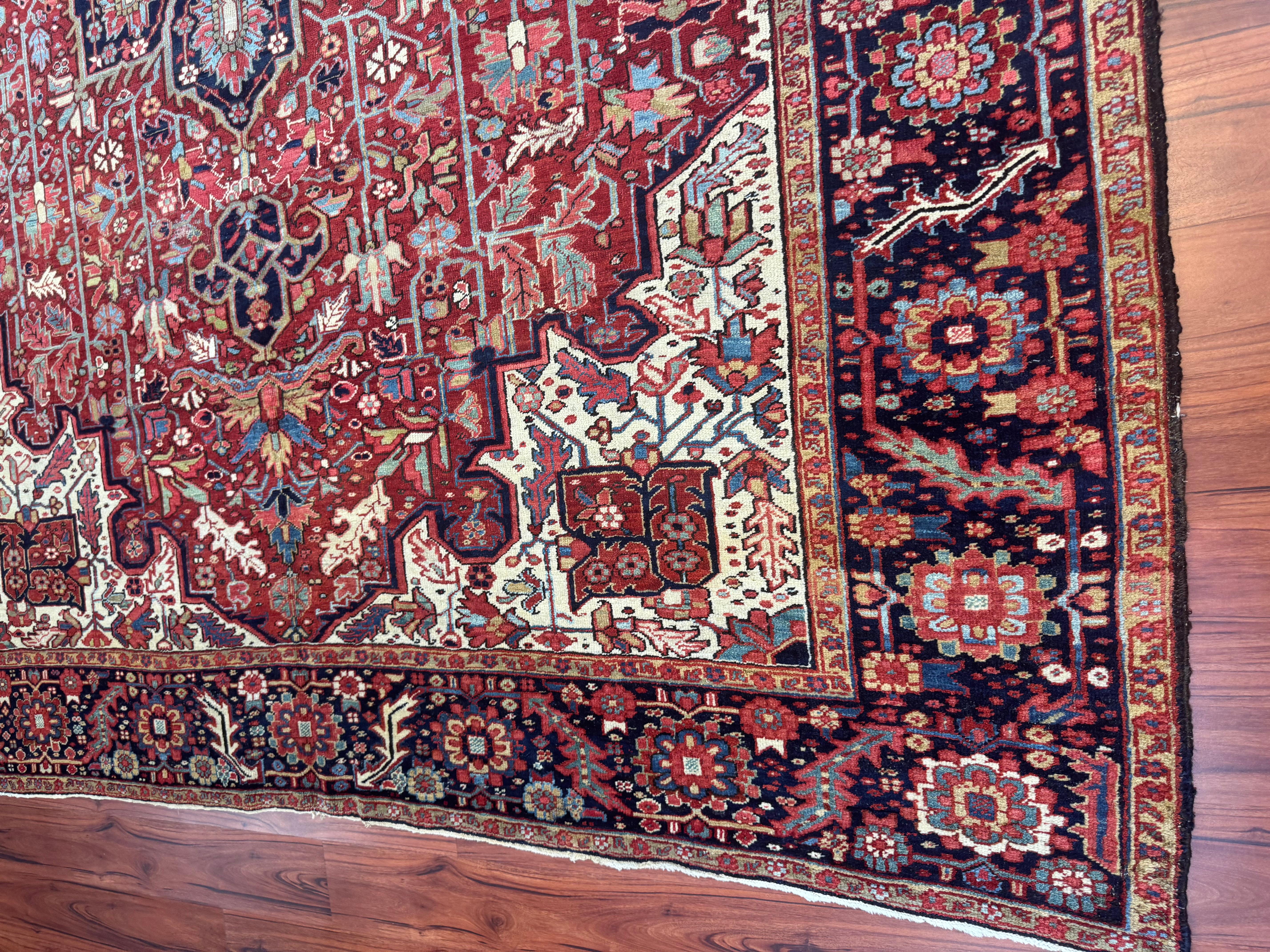 This exquisite antique Persian Heriz rug, originating from Iran in the early 1900s, is a remarkable example of Persian craftsmanship, history, and artistry. Woven by master artisans using time-honored techniques, this rug features an intricate