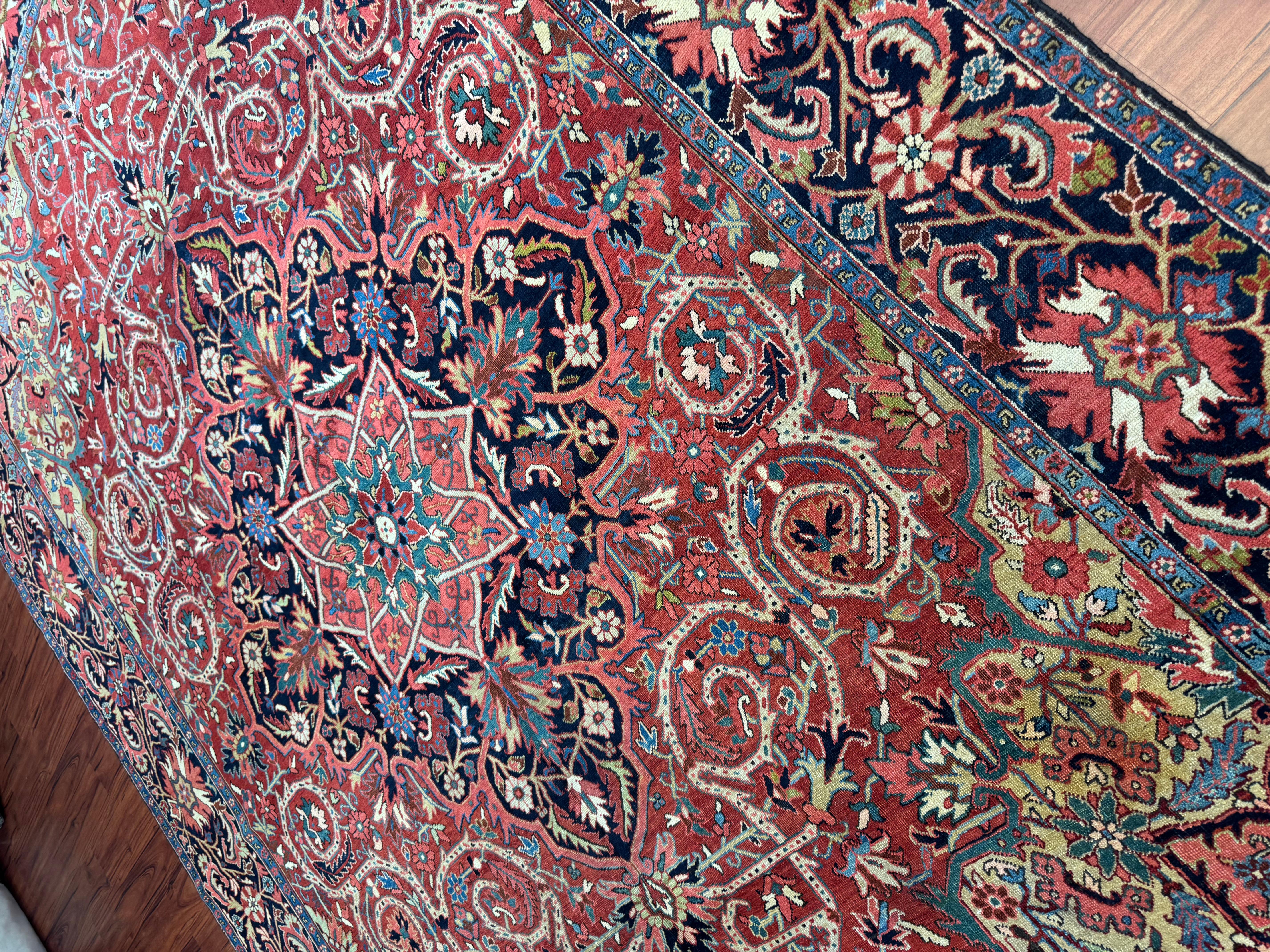 This exquisite antique Persian Heriz rug, originating from Iran in the early 1900s, is a remarkable example of Persian craftsmanship, history, and artistry. Woven by master artisans using time-honored techniques, this rug features an intricate