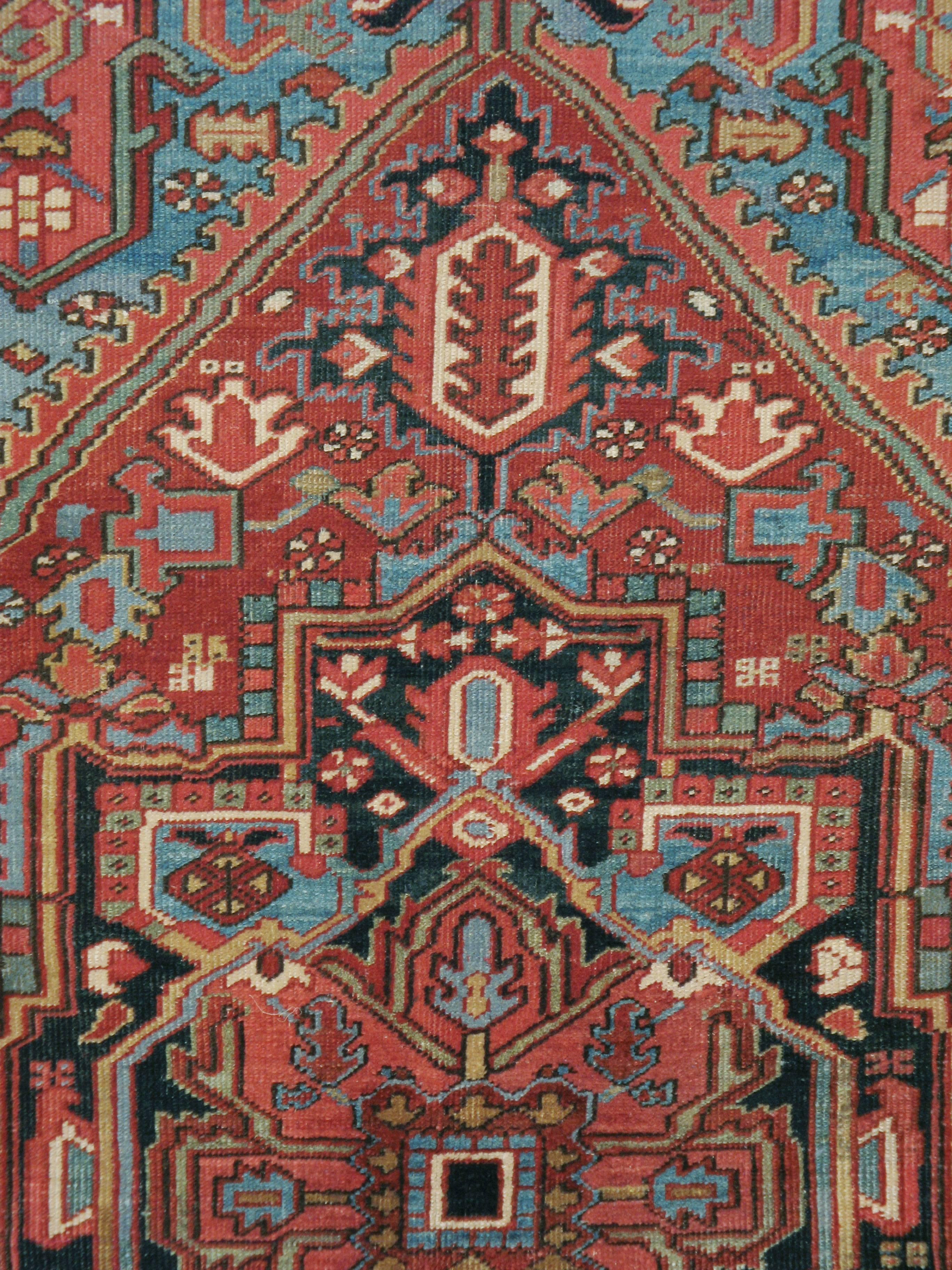 An antique Persian Heriz rug from the early 20th century.