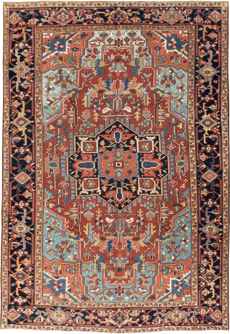 An antique Persian Heriz rug from the early 20th century. This village medallion carpet from the Heriz district in northwest Persia has an all-natural dye palette with a particularly attractive light blue field holding a red subfield. The drawing is