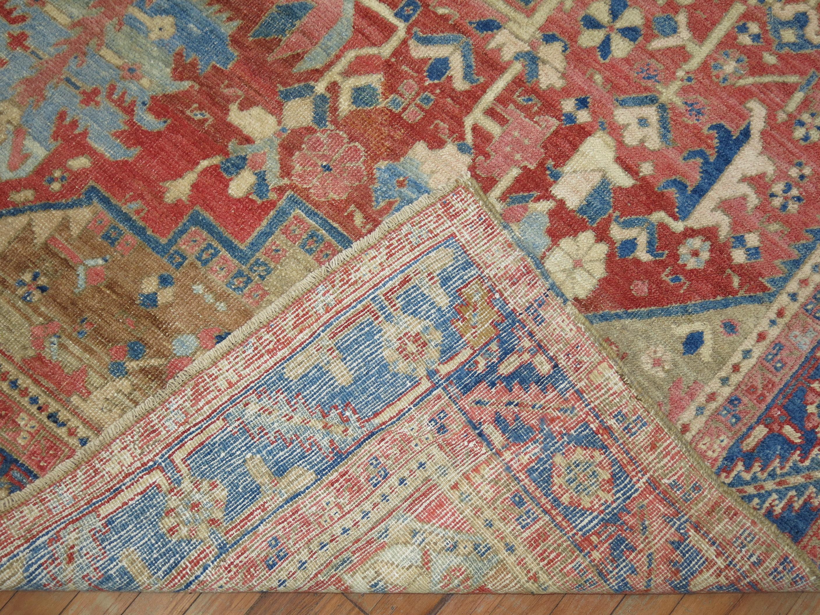 An early 20th century traditional colorful Persian Heriz carpet.

Heriz carpets are beloved for their versatility. Their geometry complements modern furnishings and their warm colors and artistic depth enhances antiques of all kinds. Their