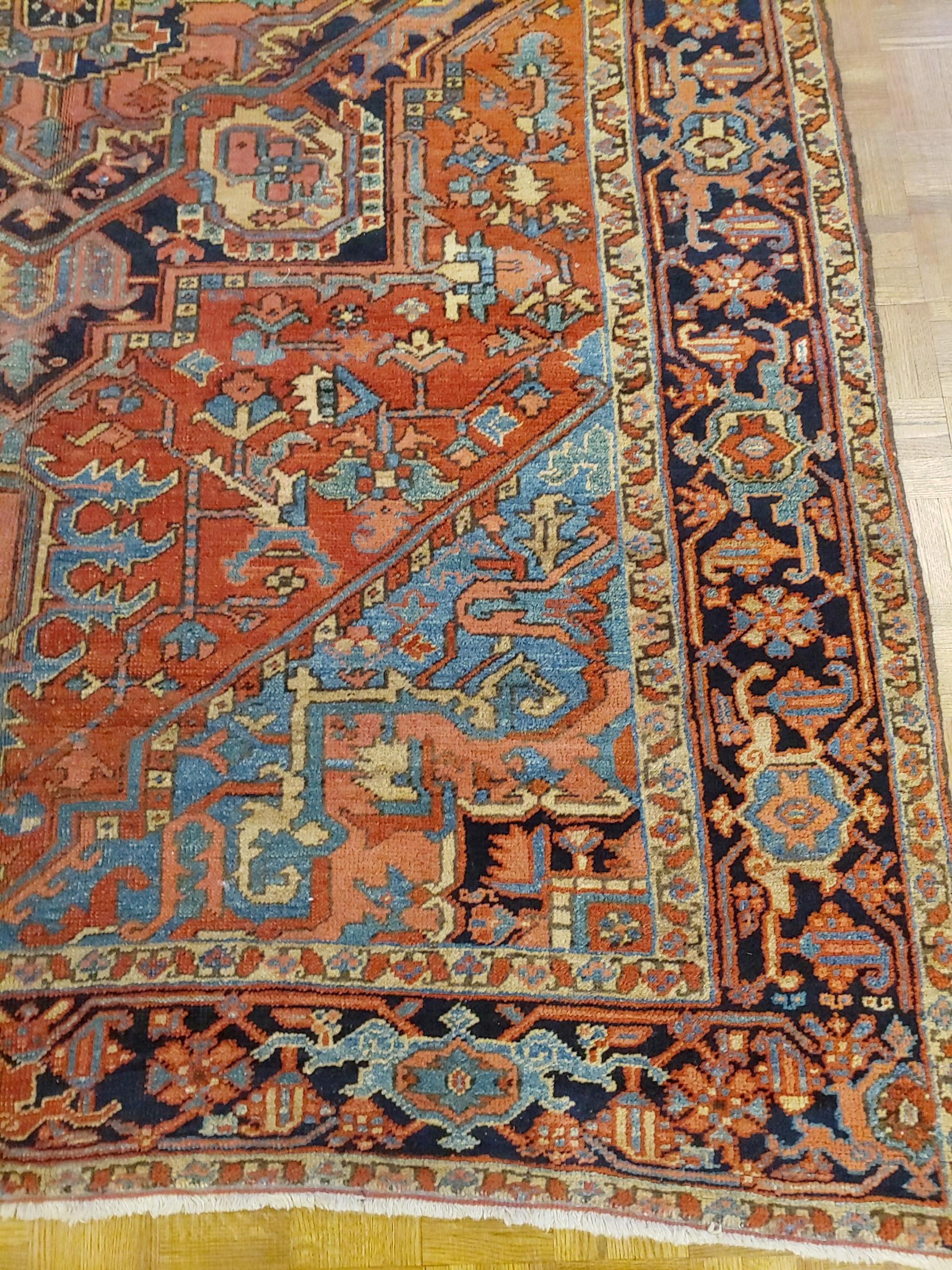 Great looking antique Persian Heriz, that some would call Serapi., from Northwest Persia. This rug has great harmony of design and colors with rust field with light blue spandrels. It has a navy border with Classic geometric Heriz Serapi motif,