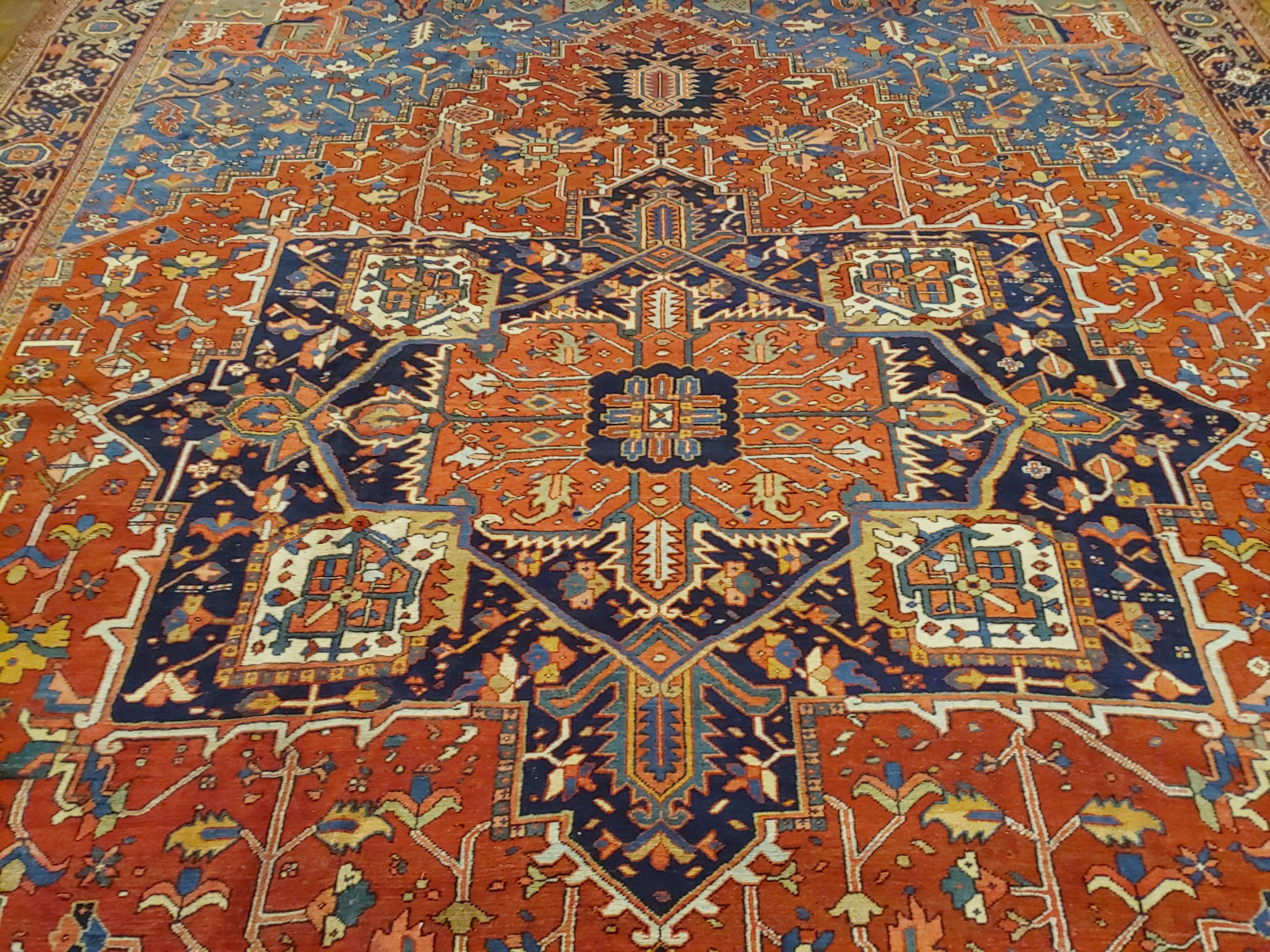 Woven Antique Persian Heriz Rug, Rust with Blue and Teal Corners, Wool, 1915 For Sale