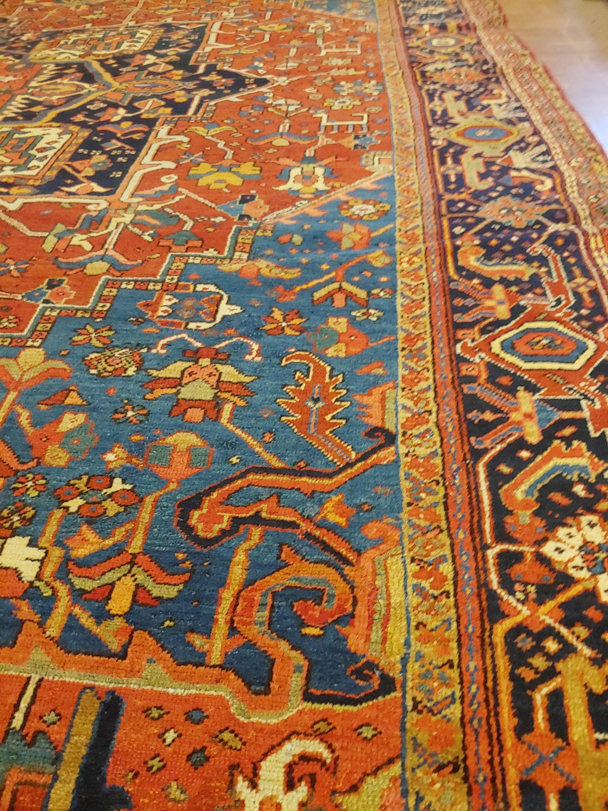Antique Persian Heriz Rug, Rust with Blue and Teal Corners, Wool, 1915 For Sale 1