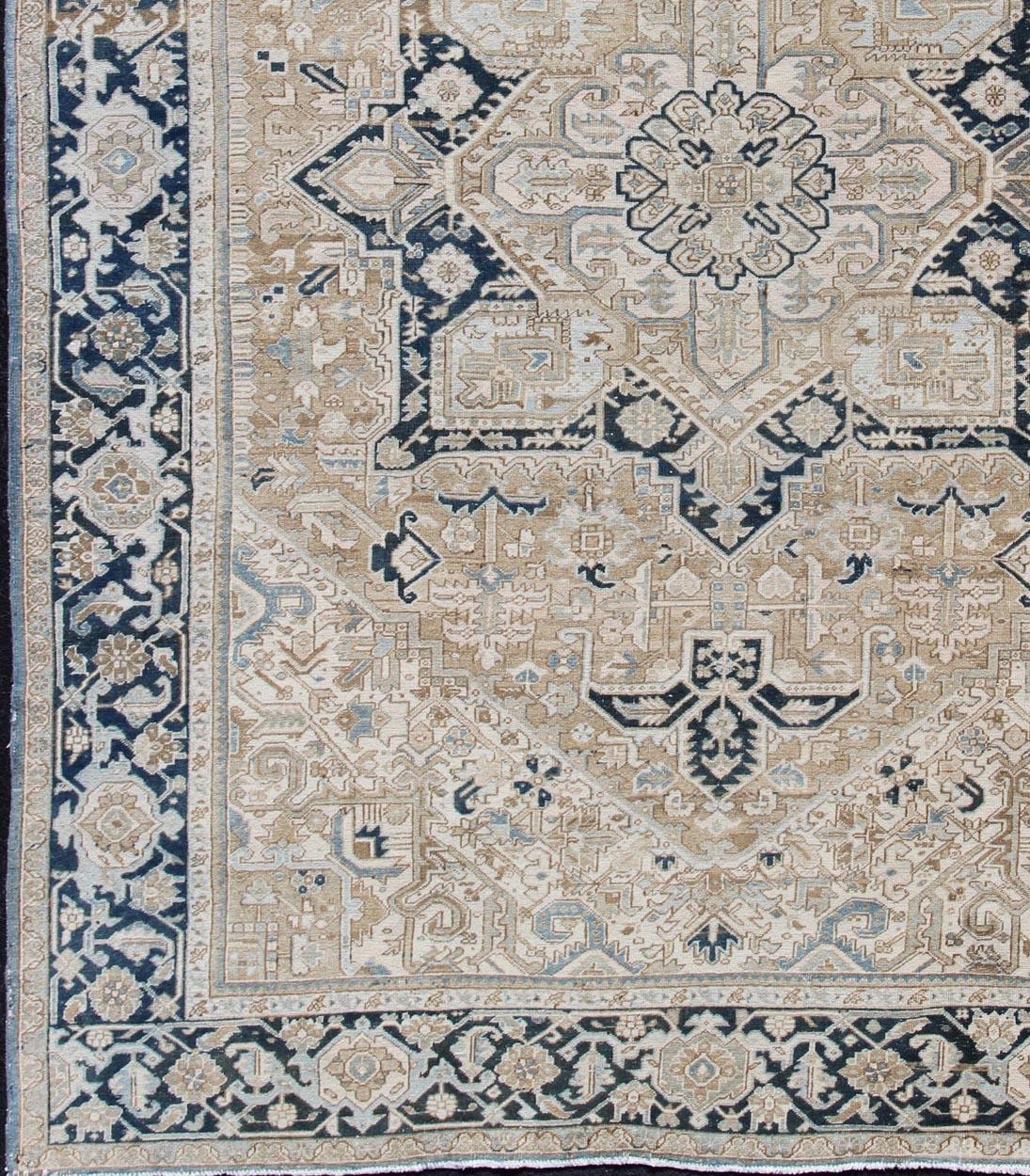 Intricately designed geometric Persian Heriz carpet. Antique Persian Heriz Rug with Geometric Medallion Design in Taupe, Blue-Gray. Keivan Woven Arts / rug 19-0814, country of origin / type: Iran / Heriz, circa 1930
Measures: 10'10 x 14'4.
This