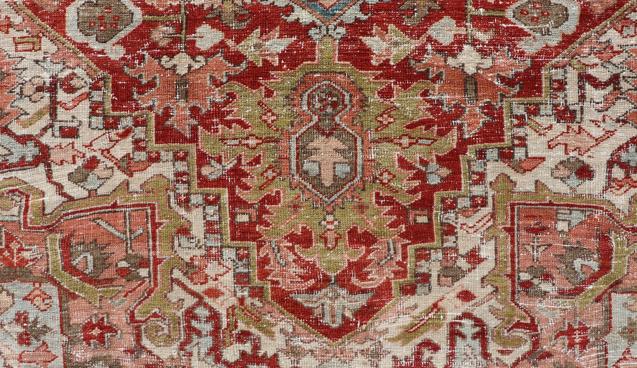 Hand-Knotted Antique Persian Heriz Rug With Geometric Medallion Design in Red & Soft Colors For Sale