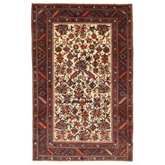 Antiker persischer Heriz-Teppich mit marineblauen und roten Blumenmotiven auf elfenbeinfarbenem Feld
