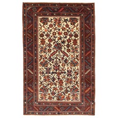 Vintage Persian Heriz Rug with Navy and Red Floral Motifs on Ivory Field