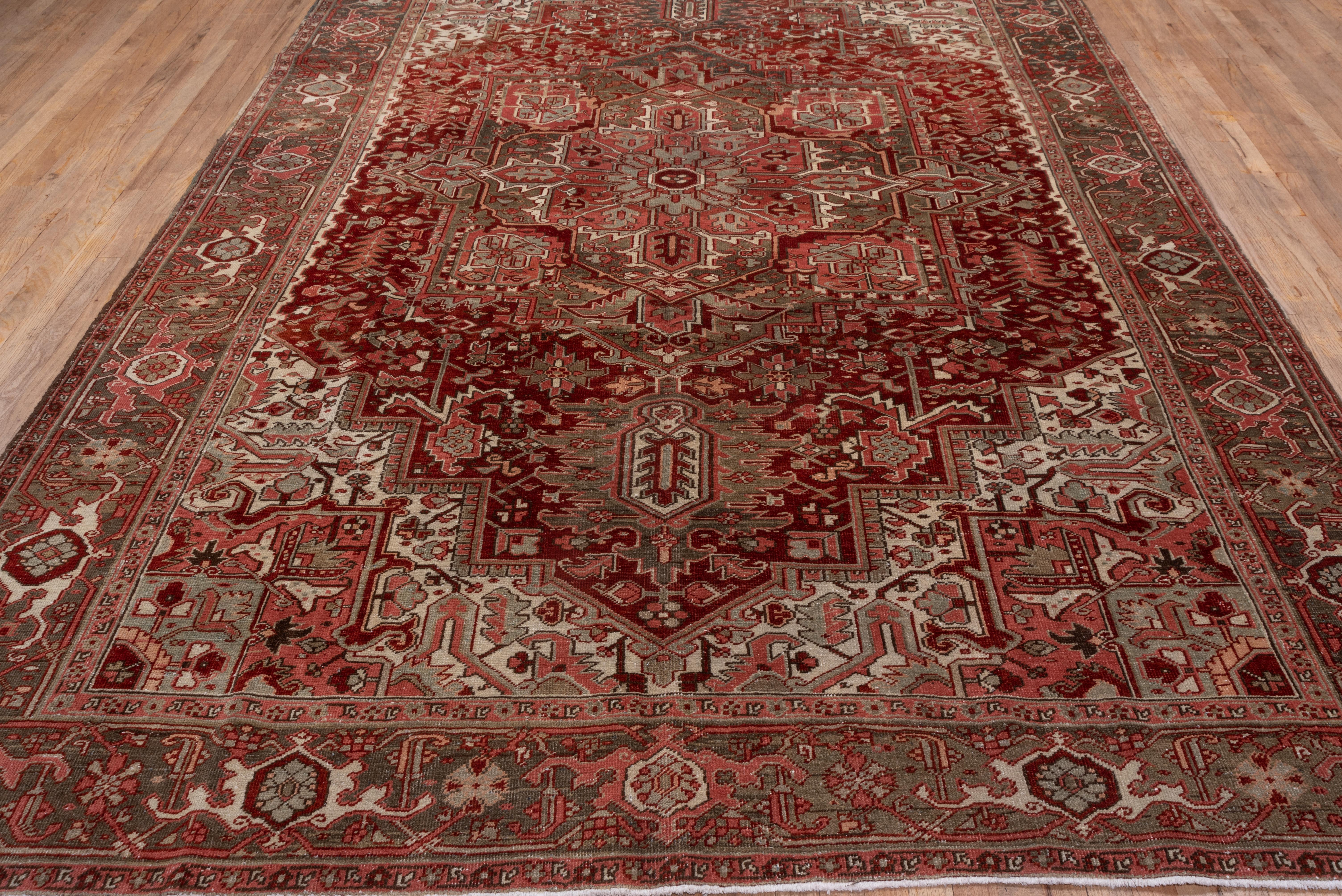 Hand-Knotted Antique Persian Heriz Rug, with Red, Olive Green & Coral Tones, circa 1930s For Sale