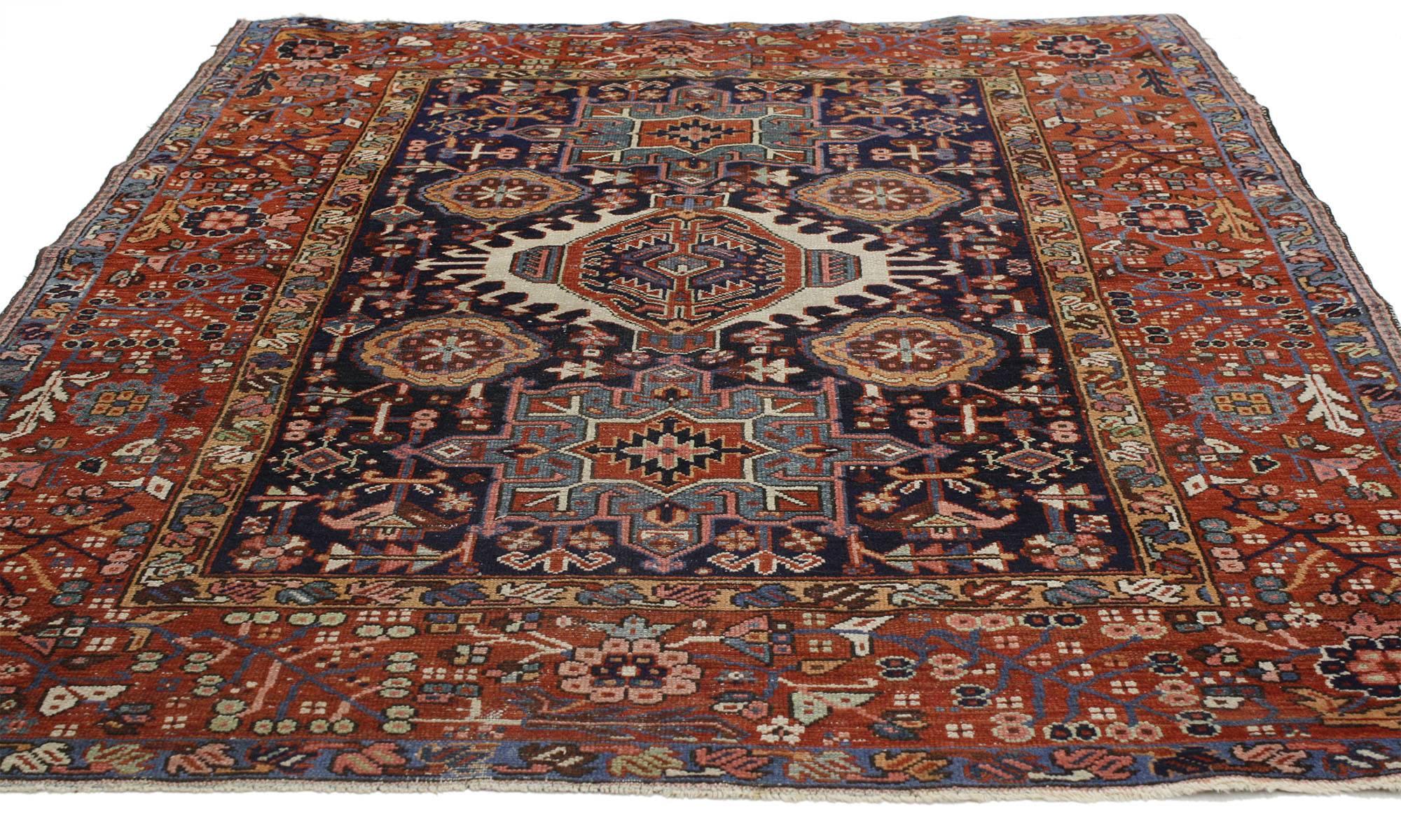 77070, antique Persian Heriz rug with tribal style. This hand-knotted wool antique Persian Heriz rug features three medallions with amulet style motifs. The central medallion outlined in a geometric Stark ivory thin border flanked by two amulets.
