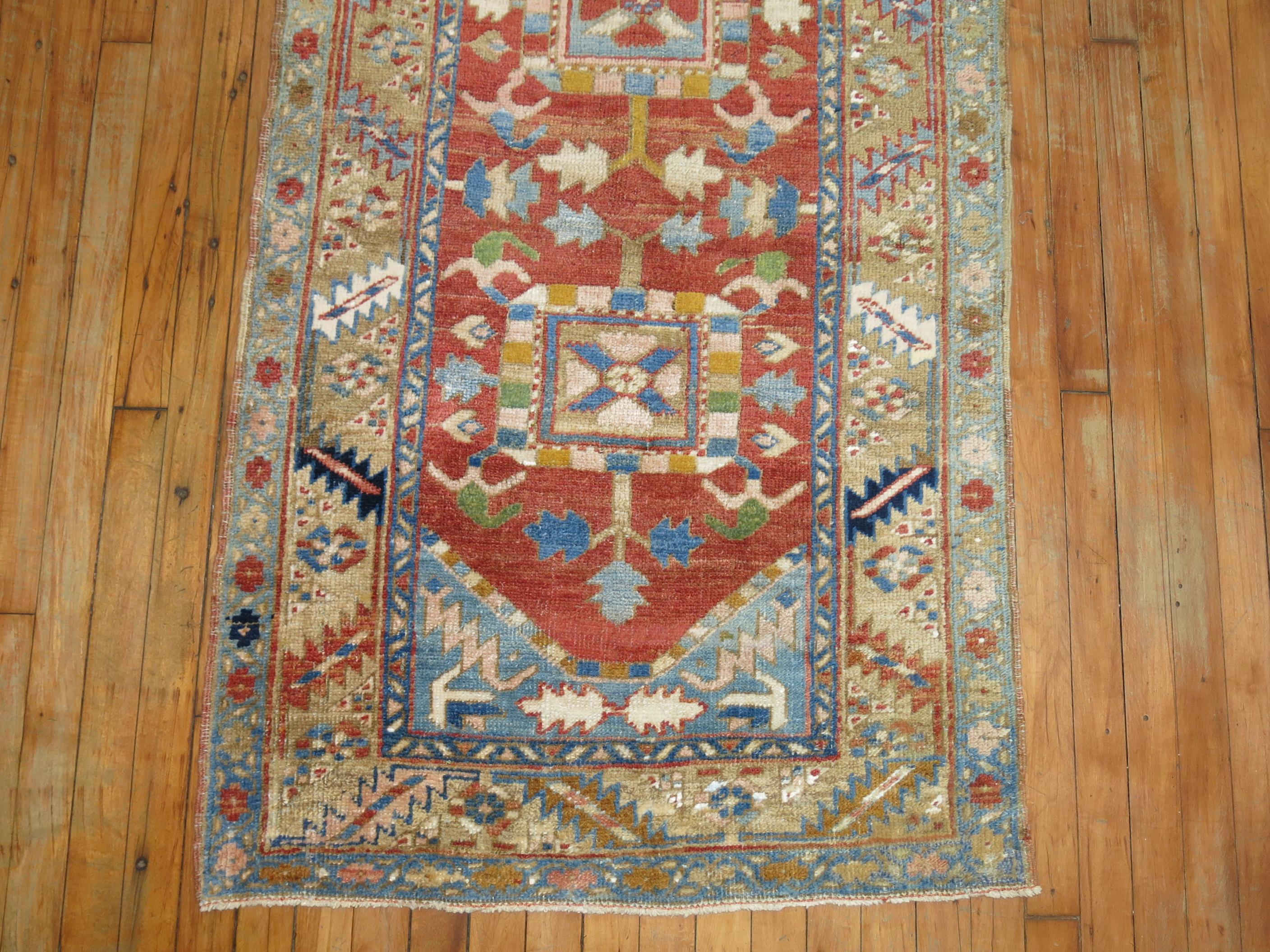 A one of a kind decorative antique Persian Heriz runner.

Measures: 2'10'' x 17'5''.

With distinctive large-scale motifs and a wide ranging palette of warm colors, the antique Heriz carpet is probably the most popular of the Persian village