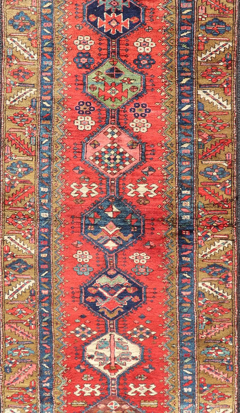 Hand-Knotted Antique Persian Heriz Runner in Reds, Blues, Pink, Ivory and Earthy Tones For Sale