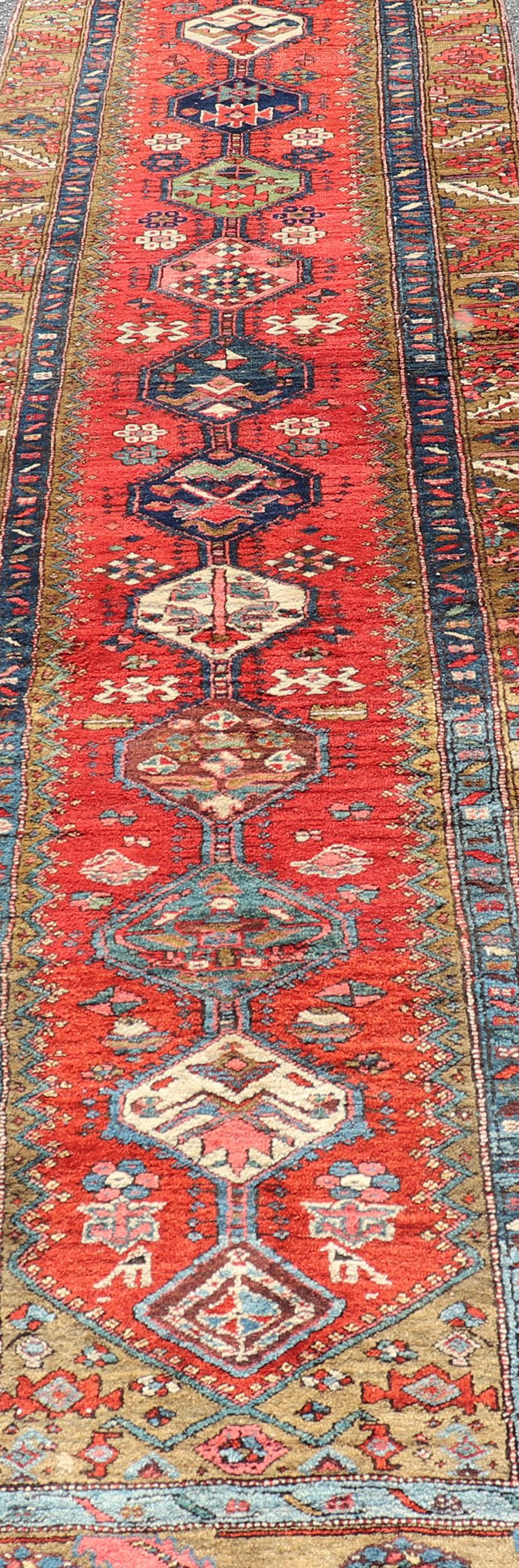 20th Century Antique Persian Heriz Runner in Reds, Blues, Pink, Ivory and Earthy Tones For Sale