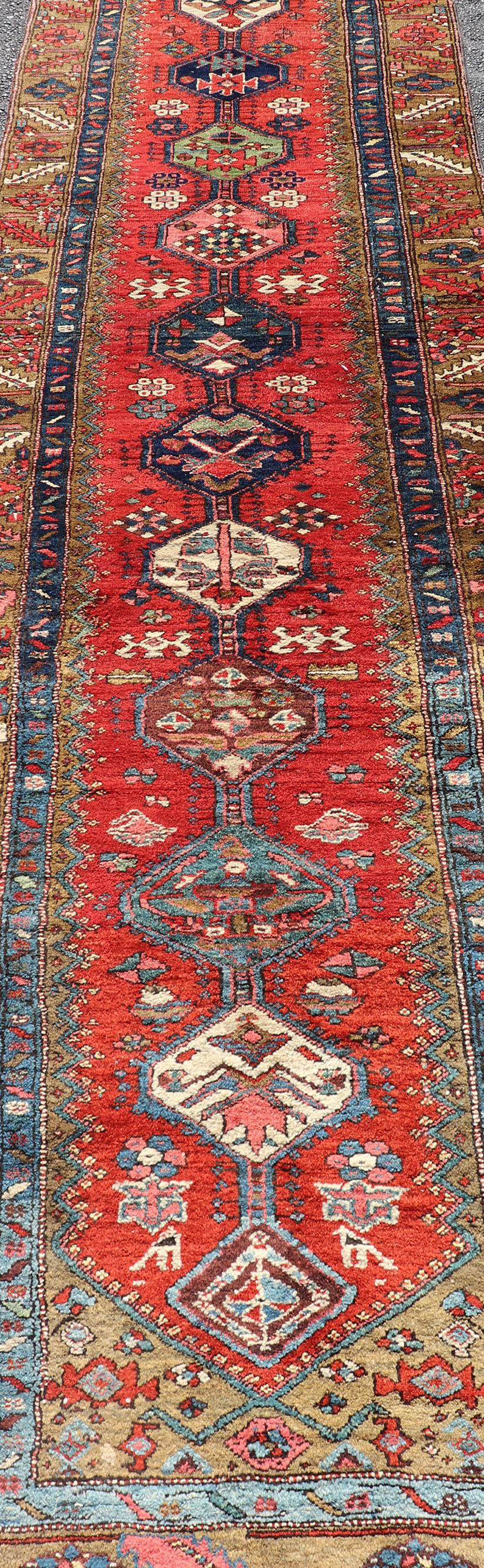 Wool Antique Persian Heriz Runner in Reds, Blues, Pink, Ivory and Earthy Tones For Sale