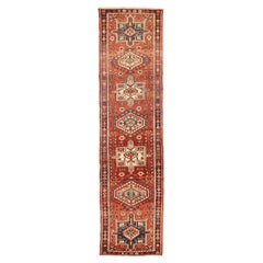 Vintage Persian Heriz Runner Rug with Ivory and Navy Tribal Motifs on Red Field