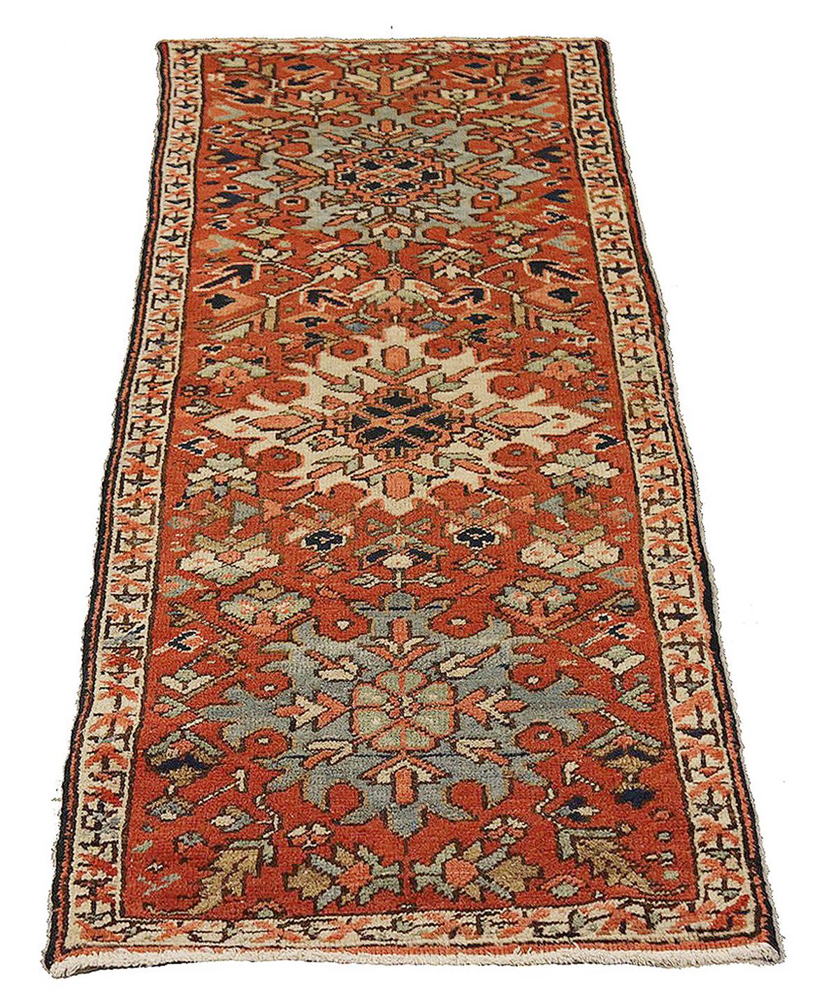 Antique Persian rug handwoven from the finest sheep’s wool and colored with all-natural vegetable dyes that are safe for humans and pets. It’s a traditional Heriz design featuring a lovely red and ivory field with colorful floral medallions. It’s a