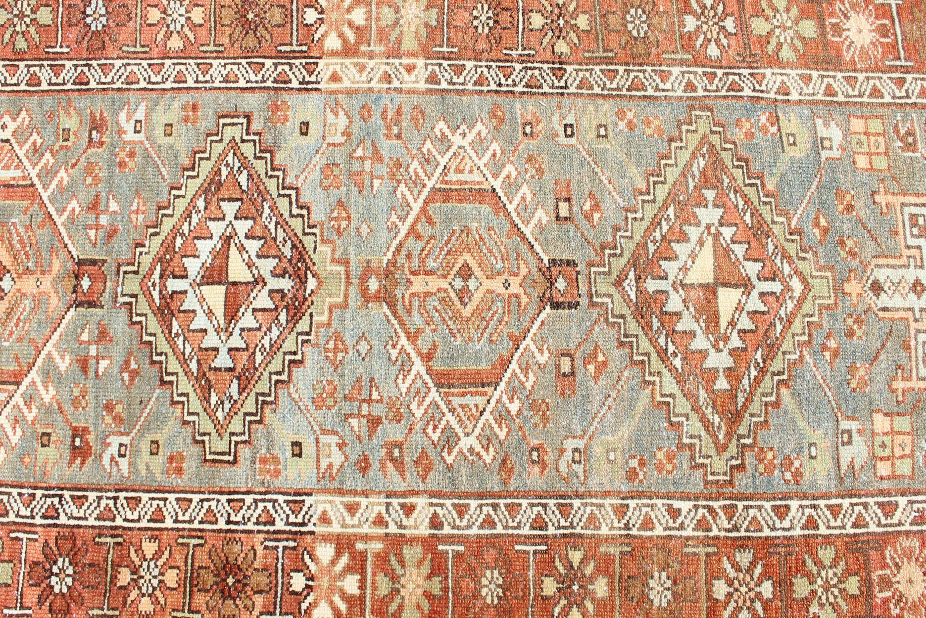 Measures: 3'0 x 13'4 

Antique Persian Heriz Runner with Geometric Medallion and Soft Colors 3'0 x 13'4. Keivan Woven Arts/ rug/SUS-2009-711, country of origin / type: Iran / Heriz, circa 1920.

An Antique Persian Heriz runner showcasing a