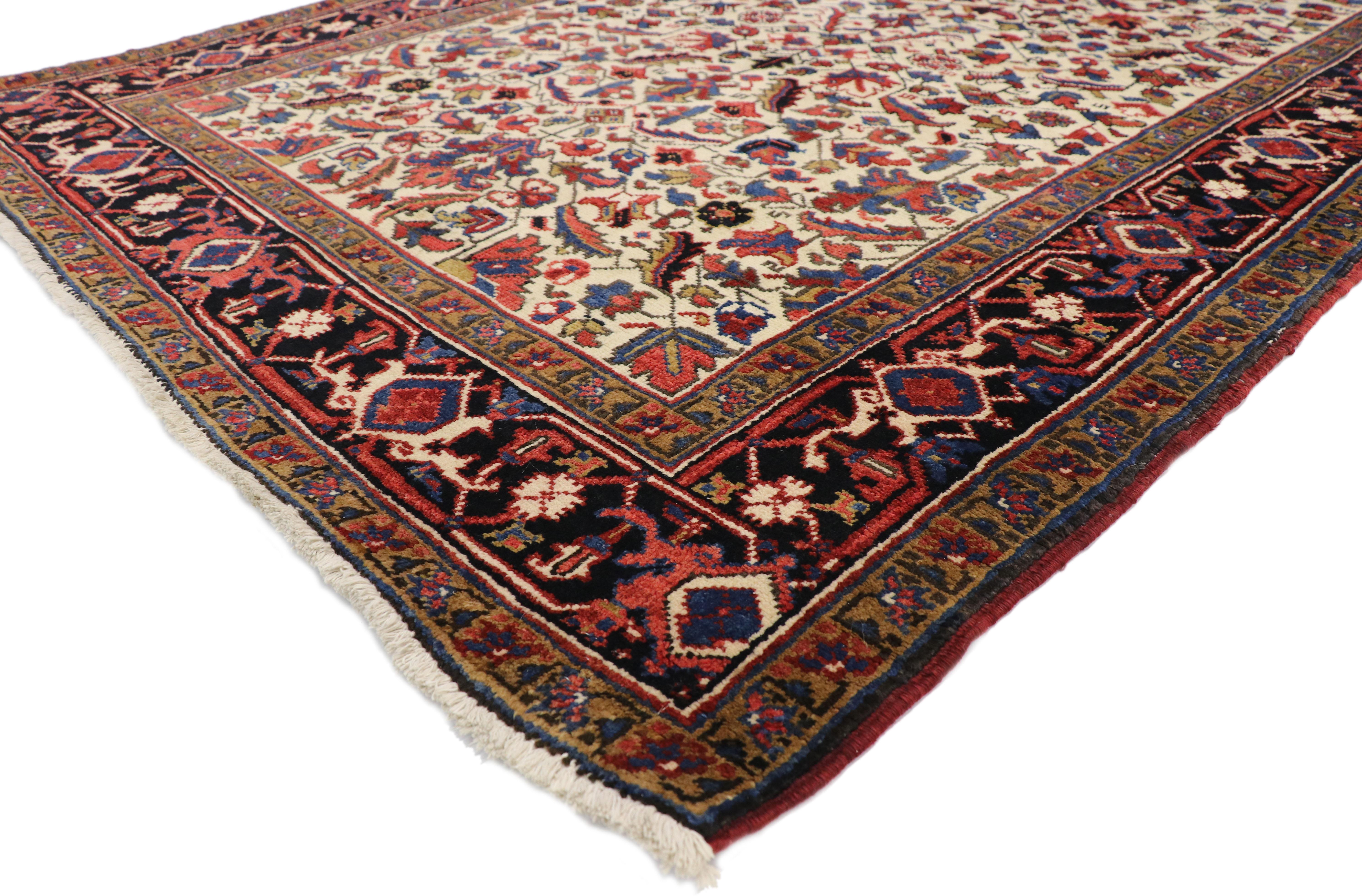 77338, antique Persian Heriz runner with Tudor Manor House style. This hand knotted wool antique Persian Heriz runner features an all-over stylized Herati pattern on an ivory field. The Herati pattern, also known as the Mahi or fish pattern, is