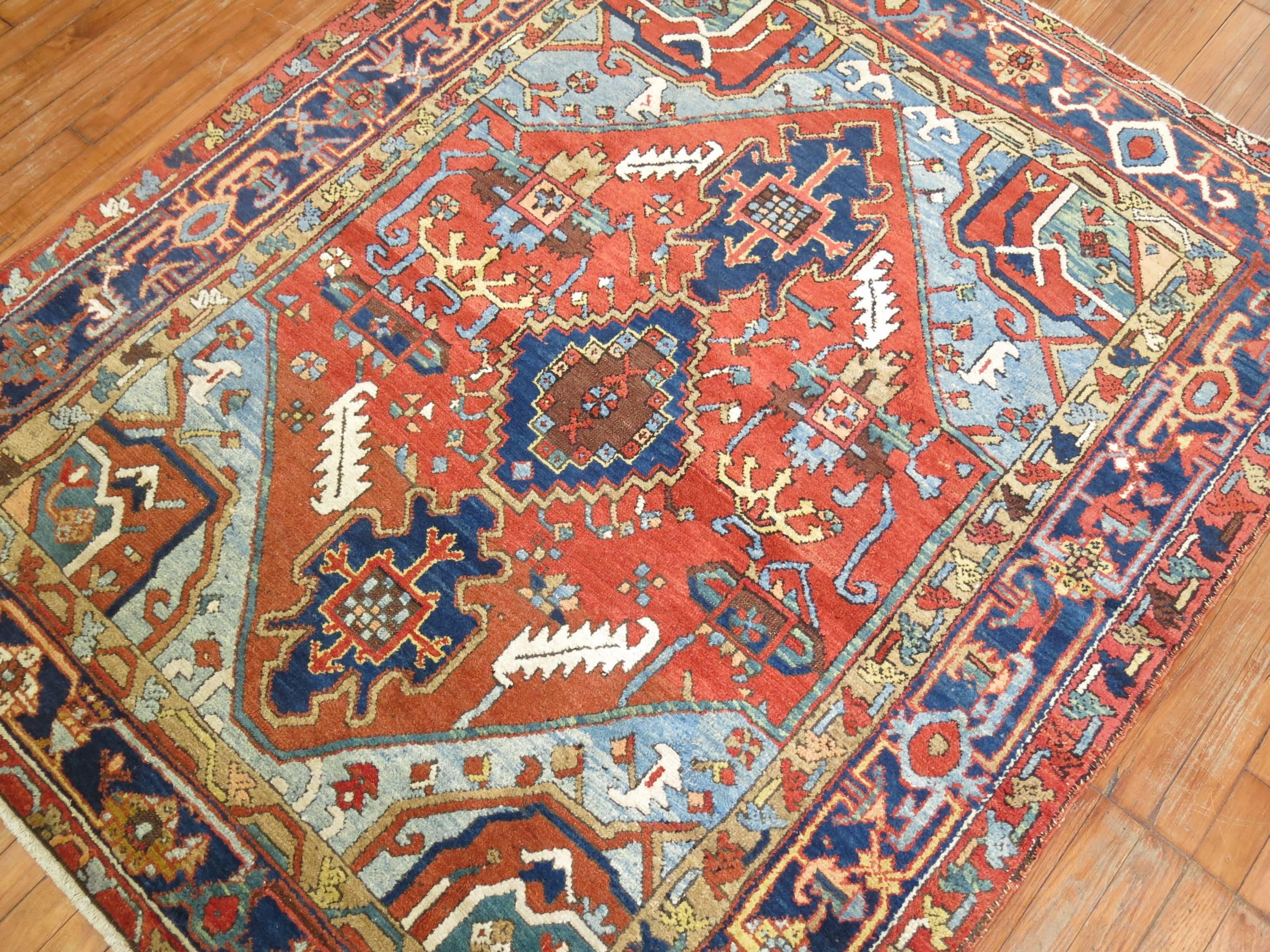 Rare compact square size Persian Heriz rug.

Heriz carpets are beloved for their versatility. Their geometry complements modern furnishings and their warm colors and artistic depth enhances antiques of all kinds. Their richness of color and
