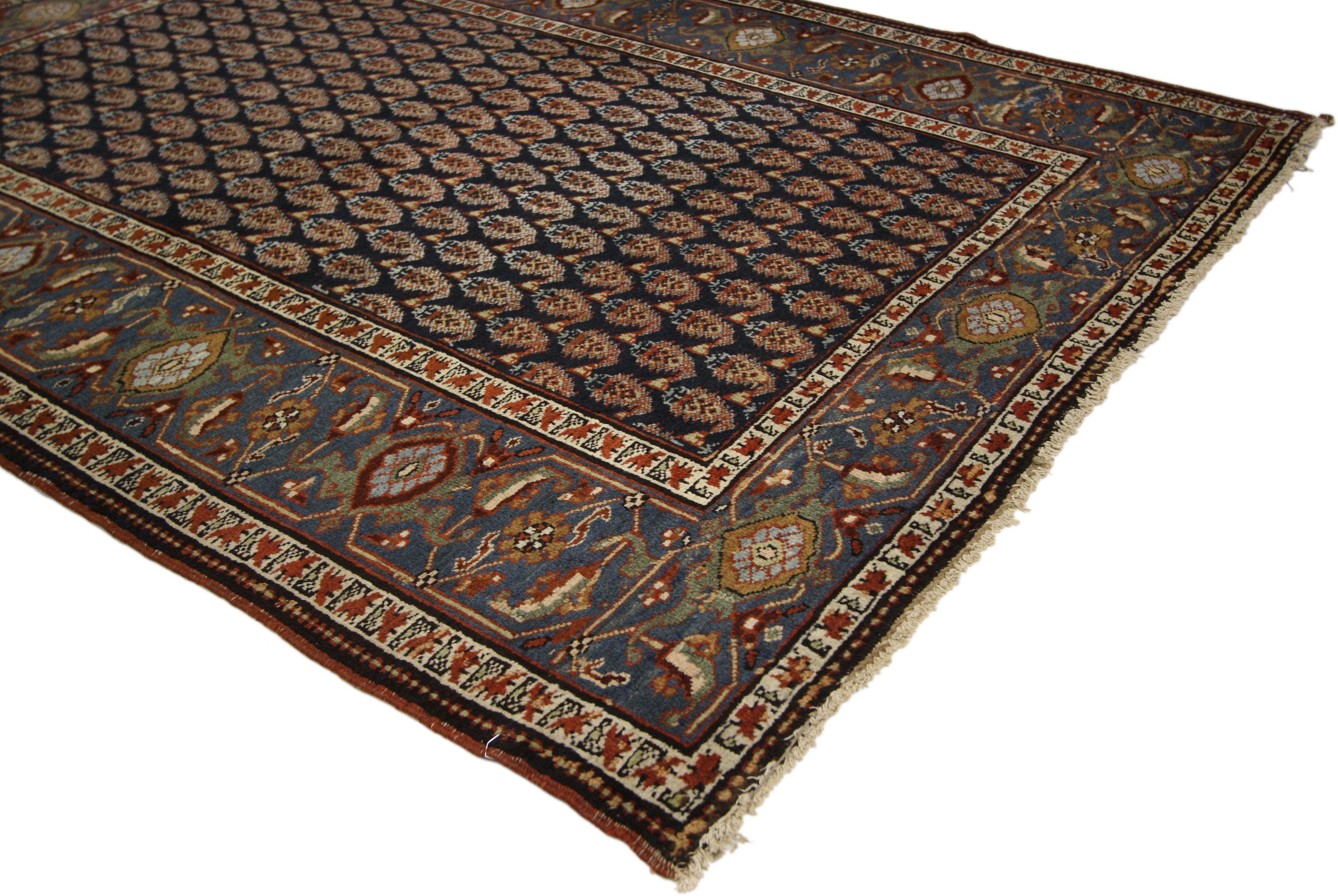 72631, antique Persian Heriz Rug with American Colonial Style and Boteh Pattern. This hand knotted wool antique Persian Heriz rug features an all-over geometric pattern of Boteh motifs. A turtle-and-vine scroll border bordered by a thin ombre