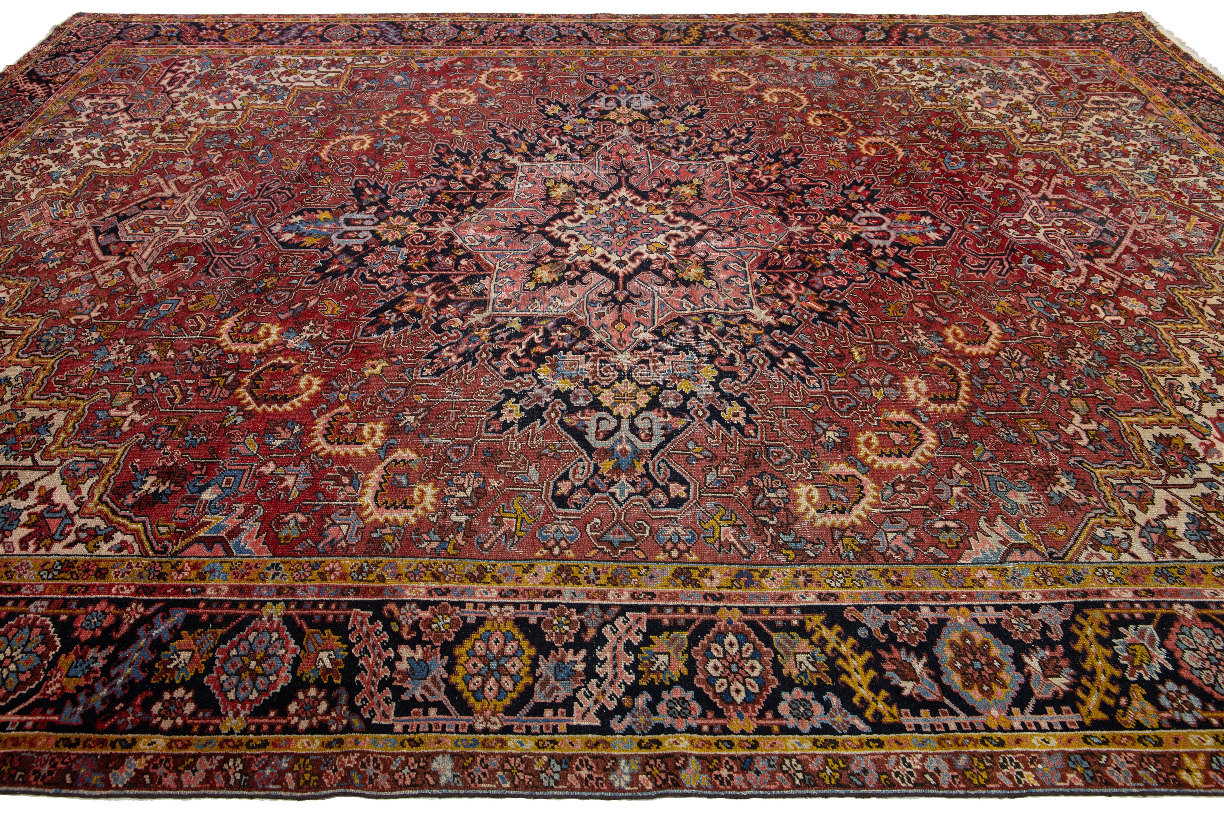 Hand-Knotted Antique Persian Heriz Wool Rug Featuring an Allover Motif In Red For Sale