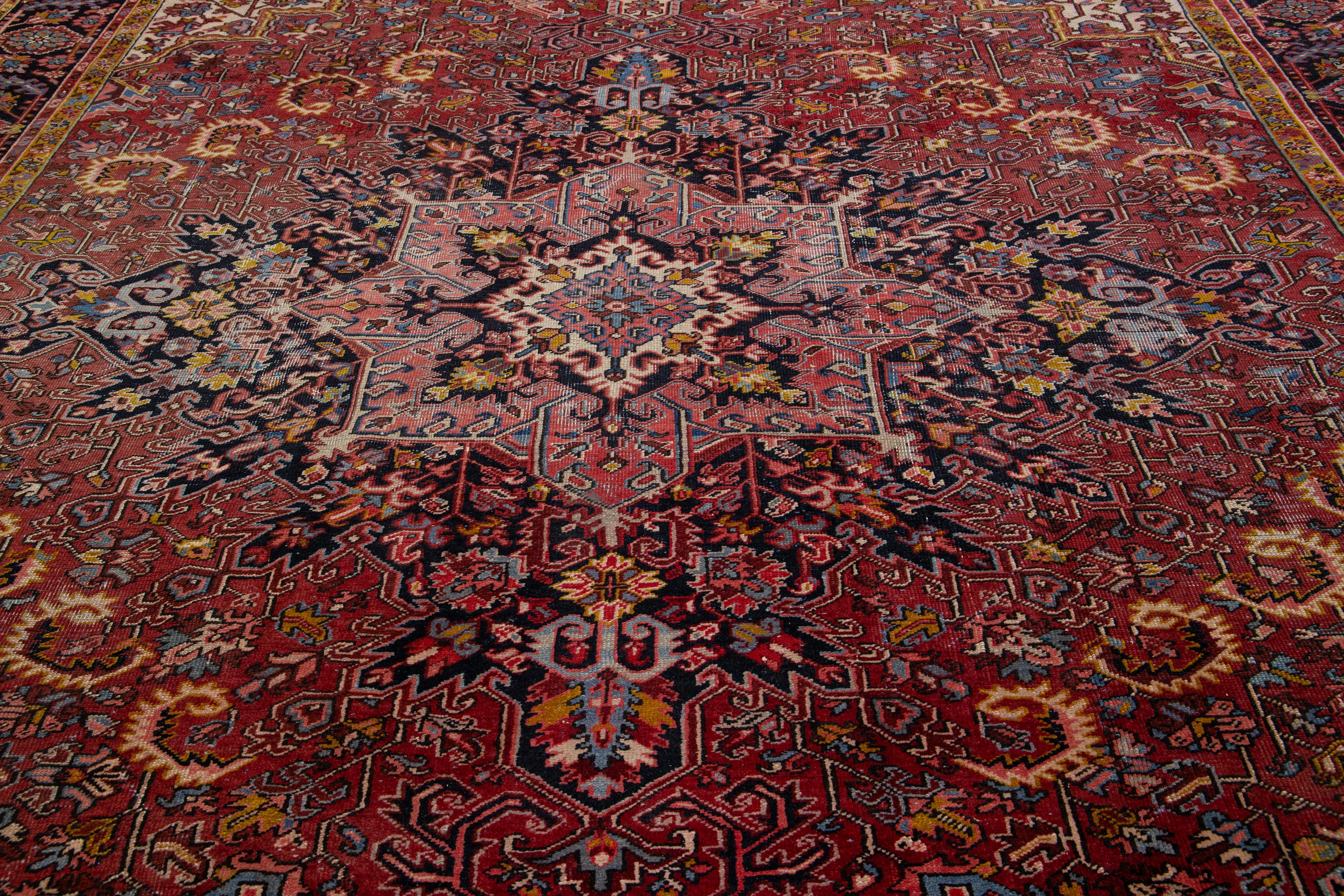 Early 20th Century Antique Persian Heriz Wool Rug Featuring an Allover Motif In Red For Sale