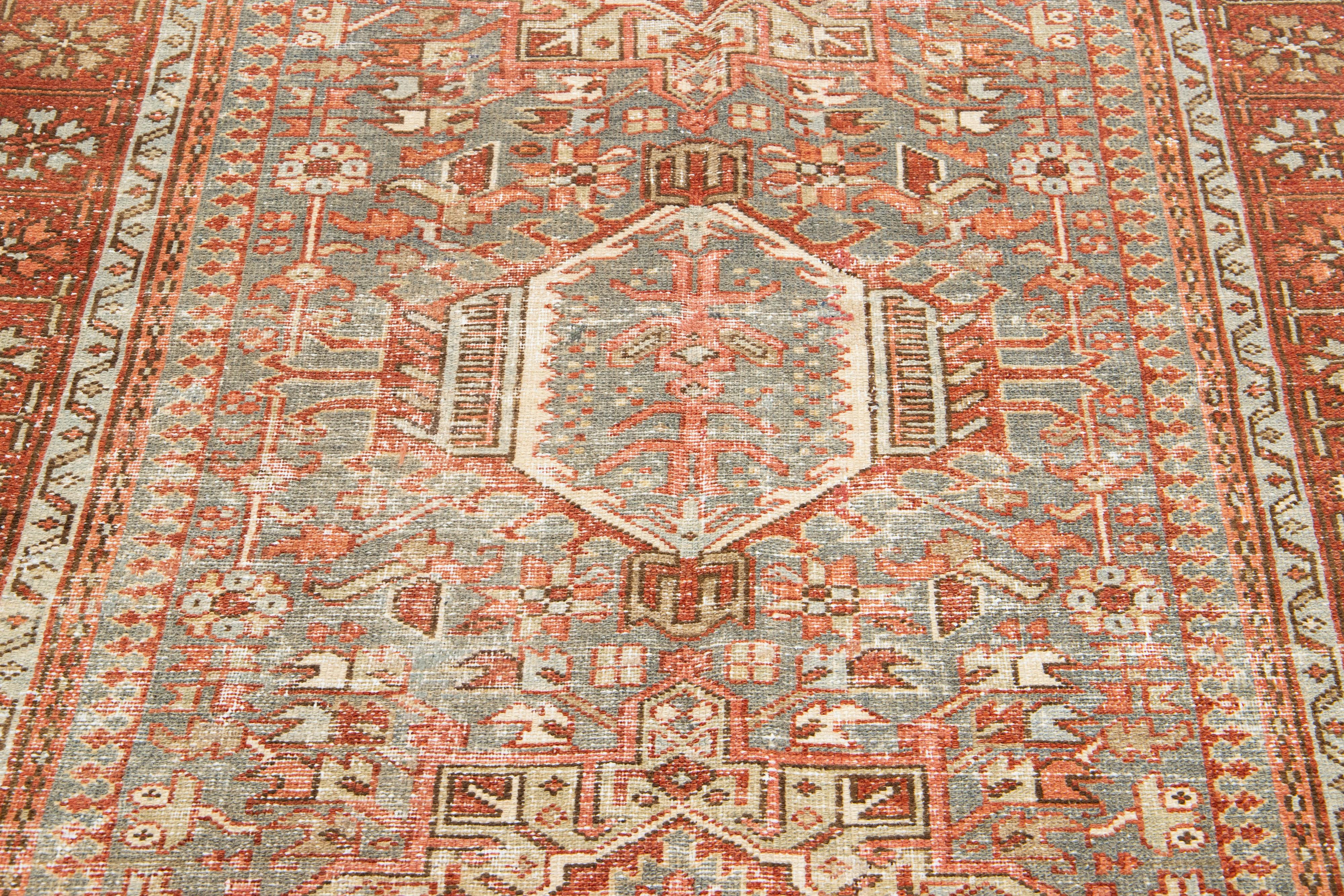 Hand-Knotted Antique Persian Heriz Wool Rug Featuring an Allover Motif In Rust For Sale