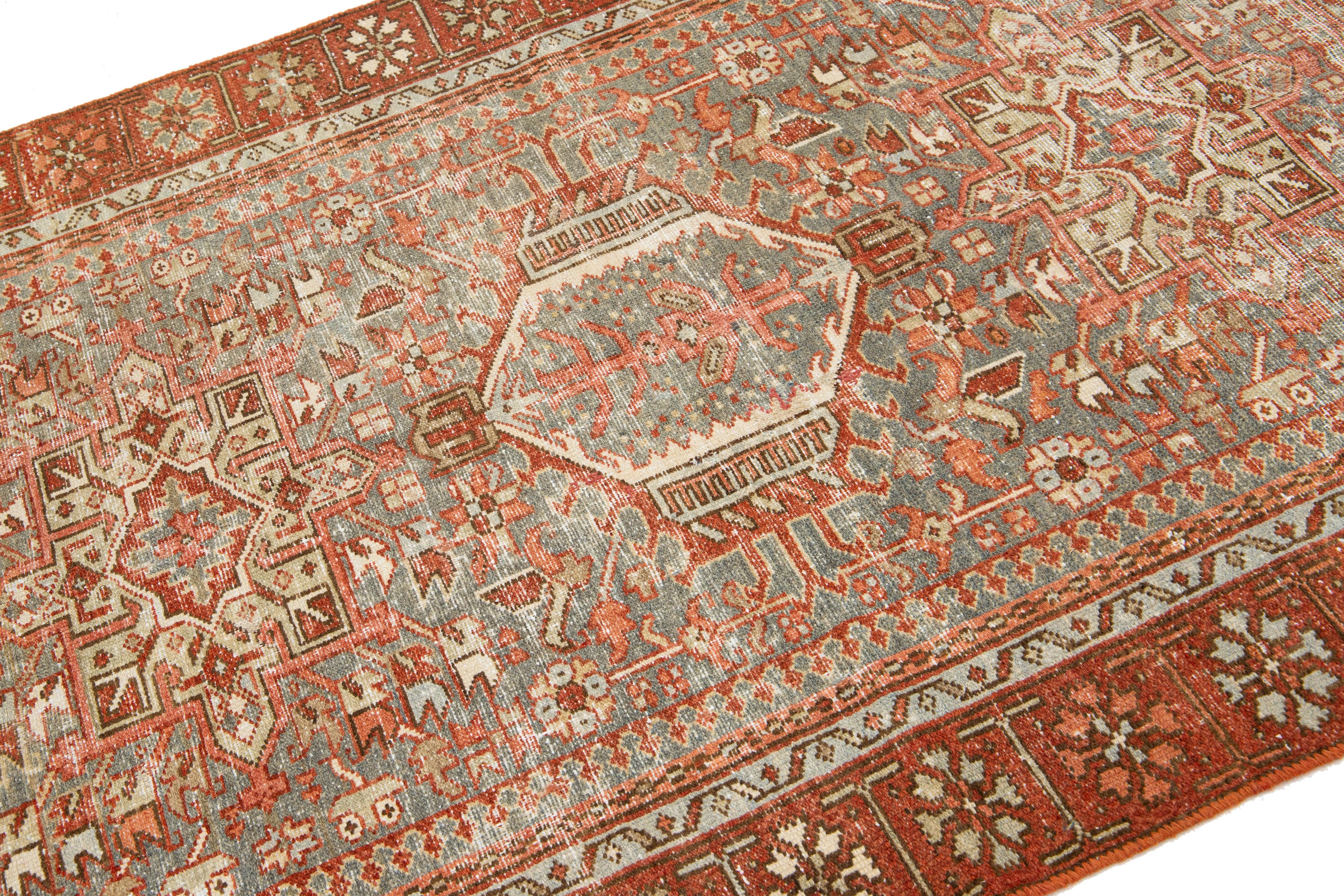 Early 20th Century Antique Persian Heriz Wool Rug Featuring an Allover Motif In Rust For Sale