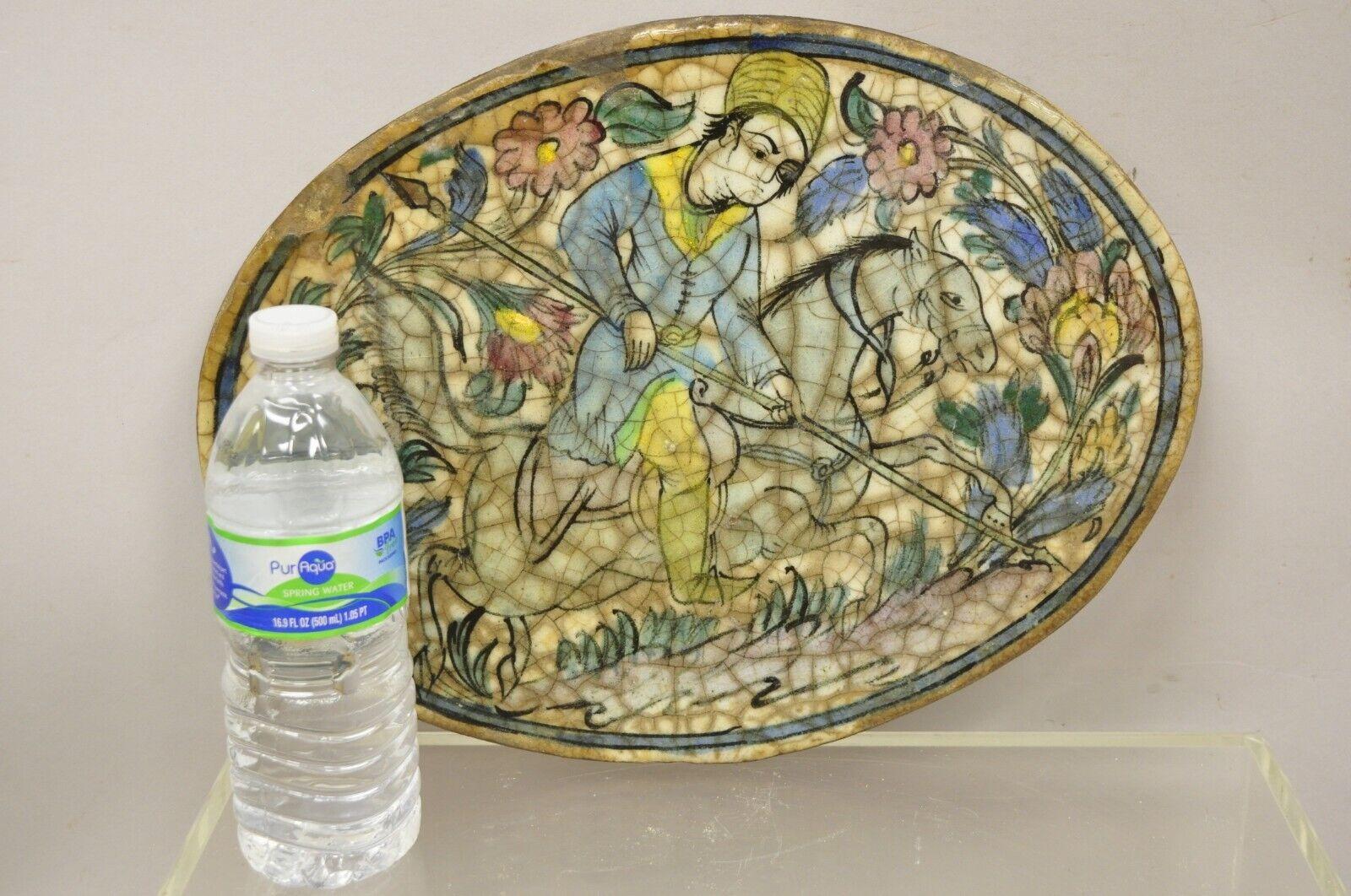 Antique Persian Iznik Qajar style ceramic pottery blue oval horse rider tile C3. Item features original crackle glazed finish, heavy ceramic pottery construction, very impressive detail, wonderful style and form. Great to mount as wall art or accent