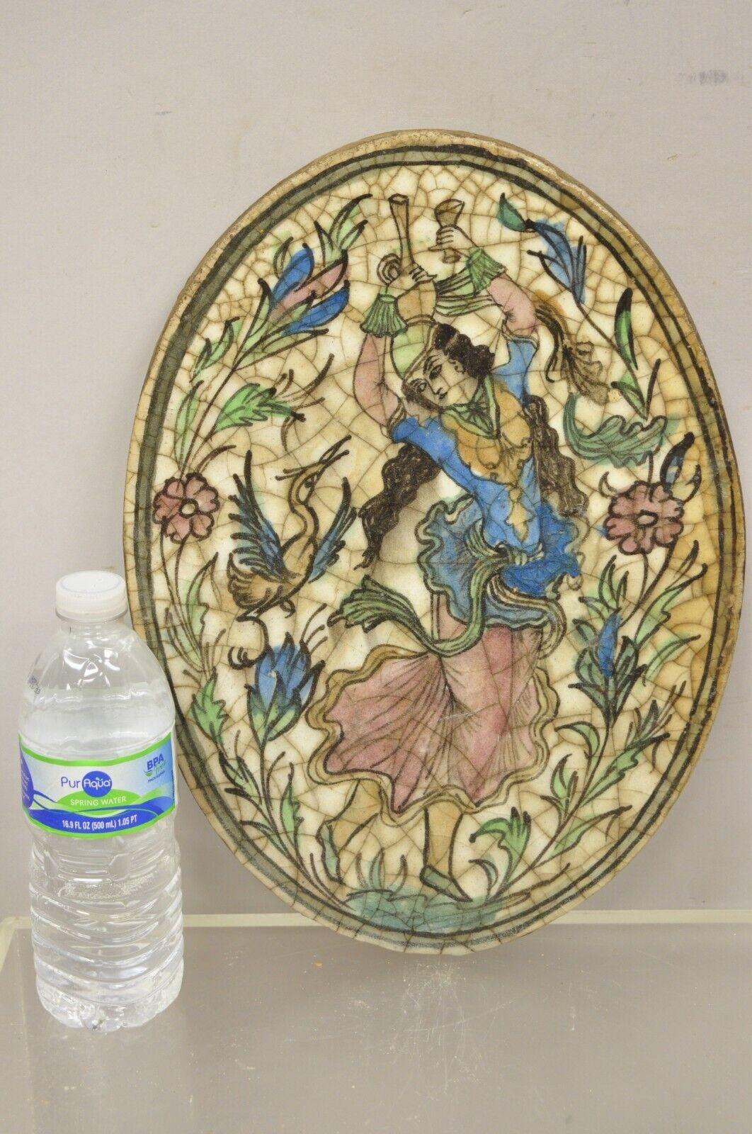 Antique Persian Iznik Qajar style ceramic pottery oval tile blue female dancer C3. Item features an original crackle glazed finish, heavy ceramic pottery construction, very impressive detail, wonderful style and form. Great to mount as wall art or