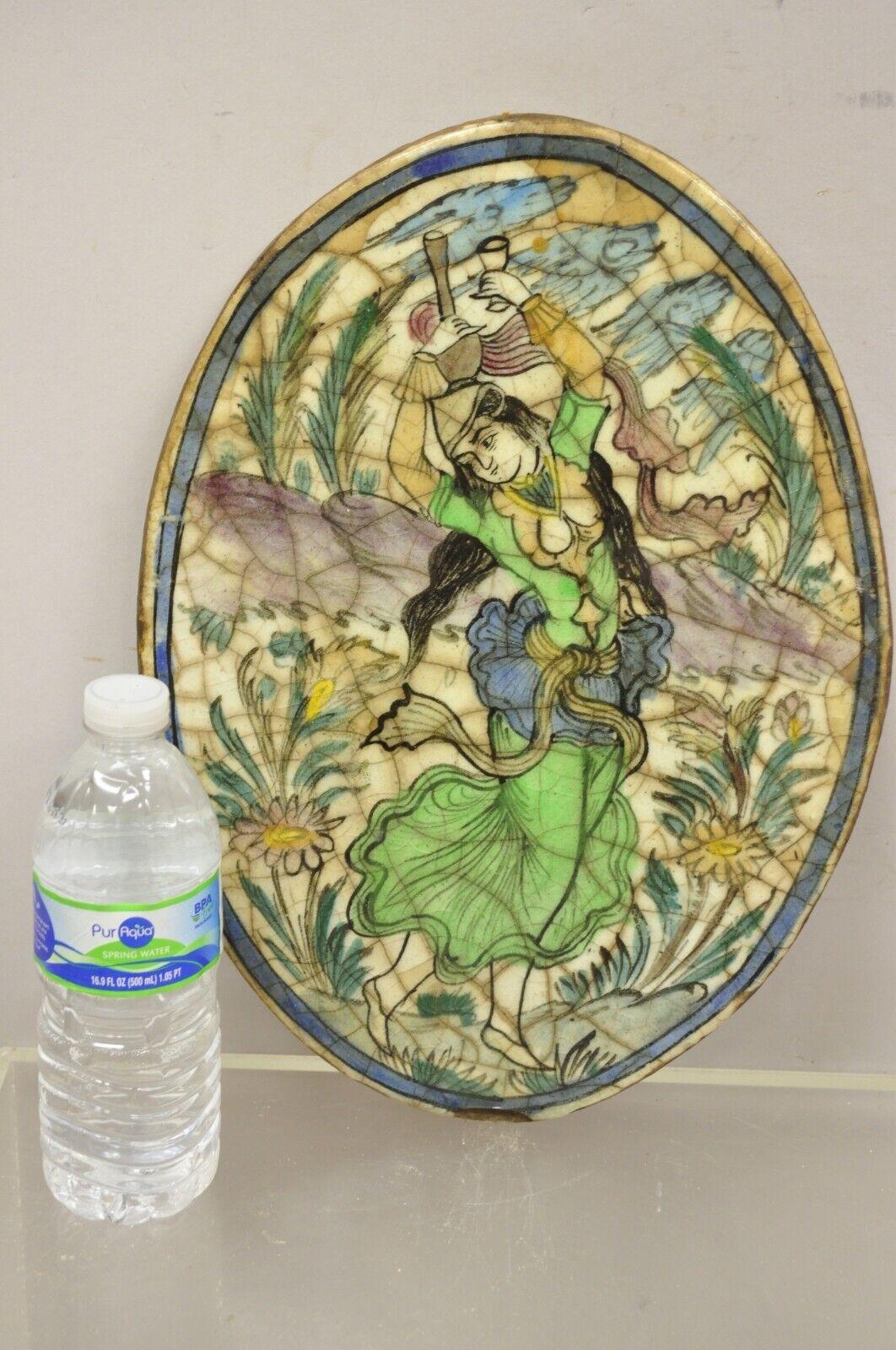 Antique Persian Iznik Qajar style ceramic pottery oval tile green lady dancer C3. Item features an original crackle glazed finish, heavy ceramic pottery construction, very impressive detail, wonderful style and form. Great to mount as wall art or