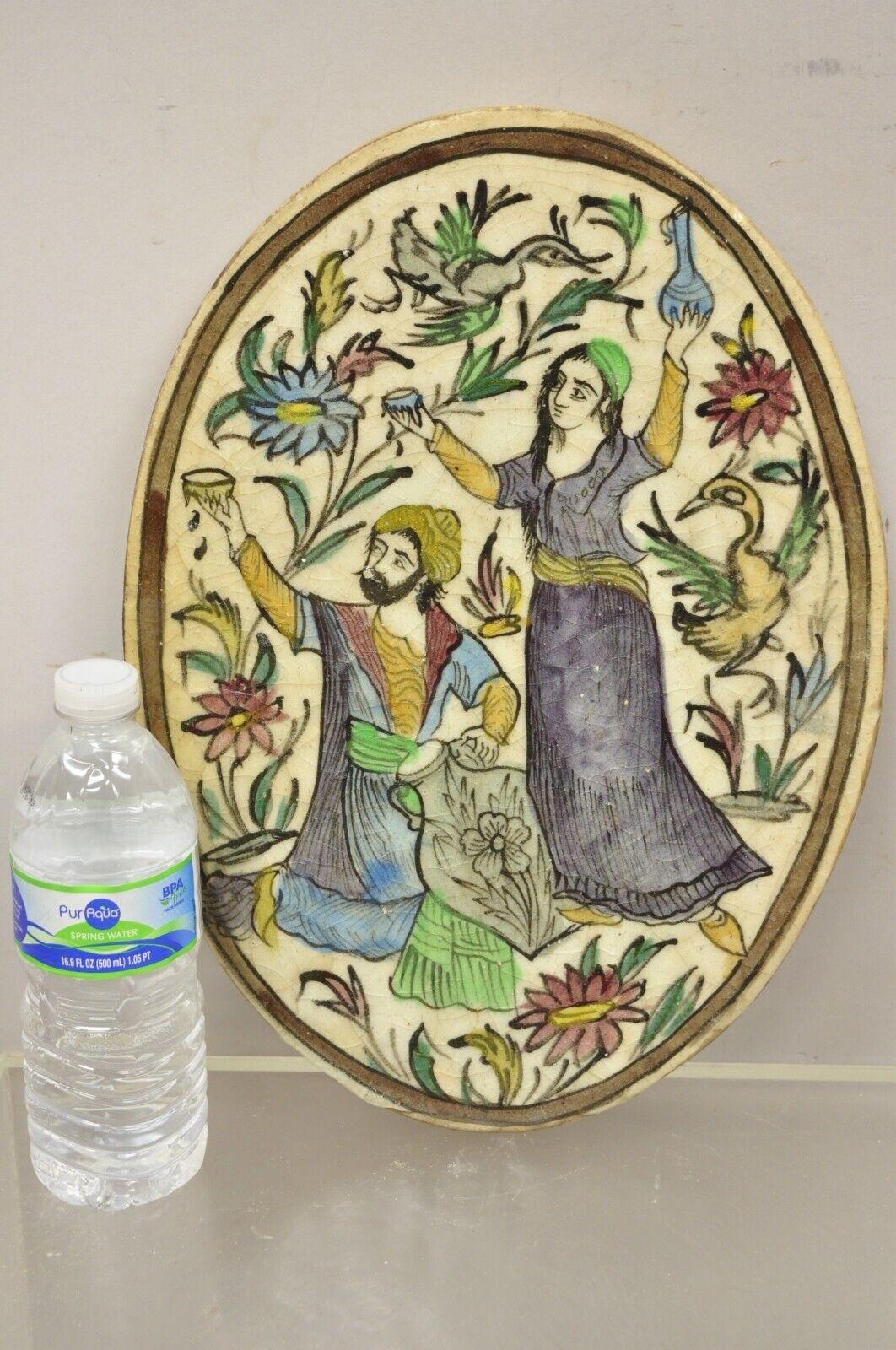Antique Persian Iznik Qajar style ceramic pottery oval tile woman and man with jugs C3. Item features original crackle glazed finish, heavy ceramic pottery construction, very impressive detail, wonderful style and form. Great to mount as wall art or
