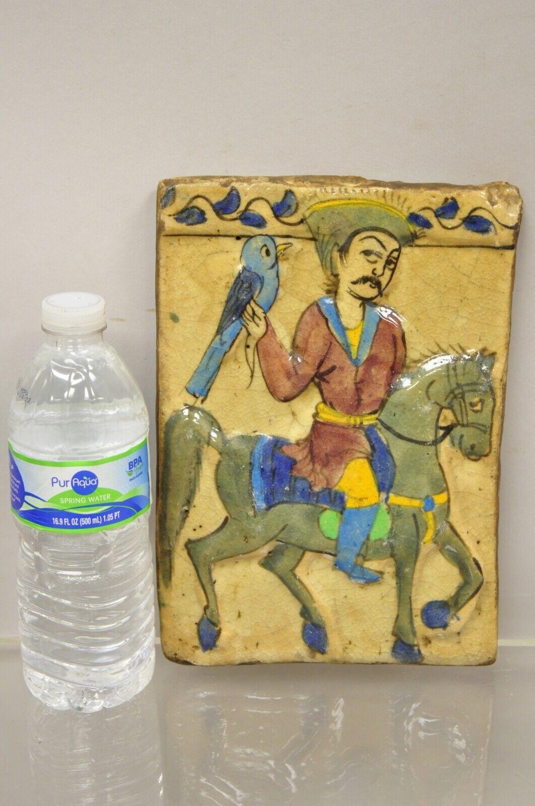 Antique Persian Iznik Qajar Style ceramic pottery tile horse rider with Blue Bird C5. Item features original crackle glazed finish, heavy ceramic pottery construction, very impressive detail, wonderful style and form. Great to mount as wall art or