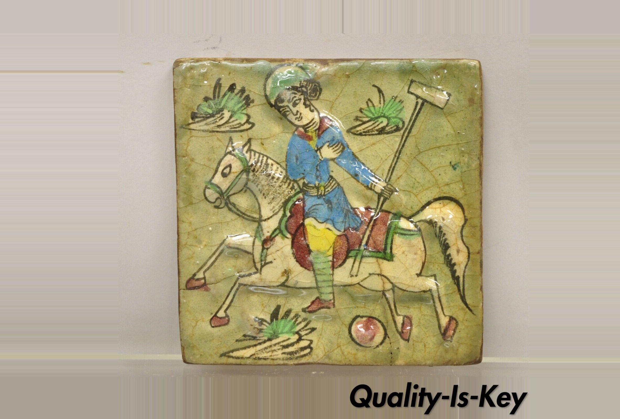 Antique Persian Iznik Qajar style square ceramic pottery tile polo playerr in blue garb on horse C5. Item features original crackle glazed finish, heavy ceramic pottery construction, very impressive detail, wonderful style and form. Great to mount