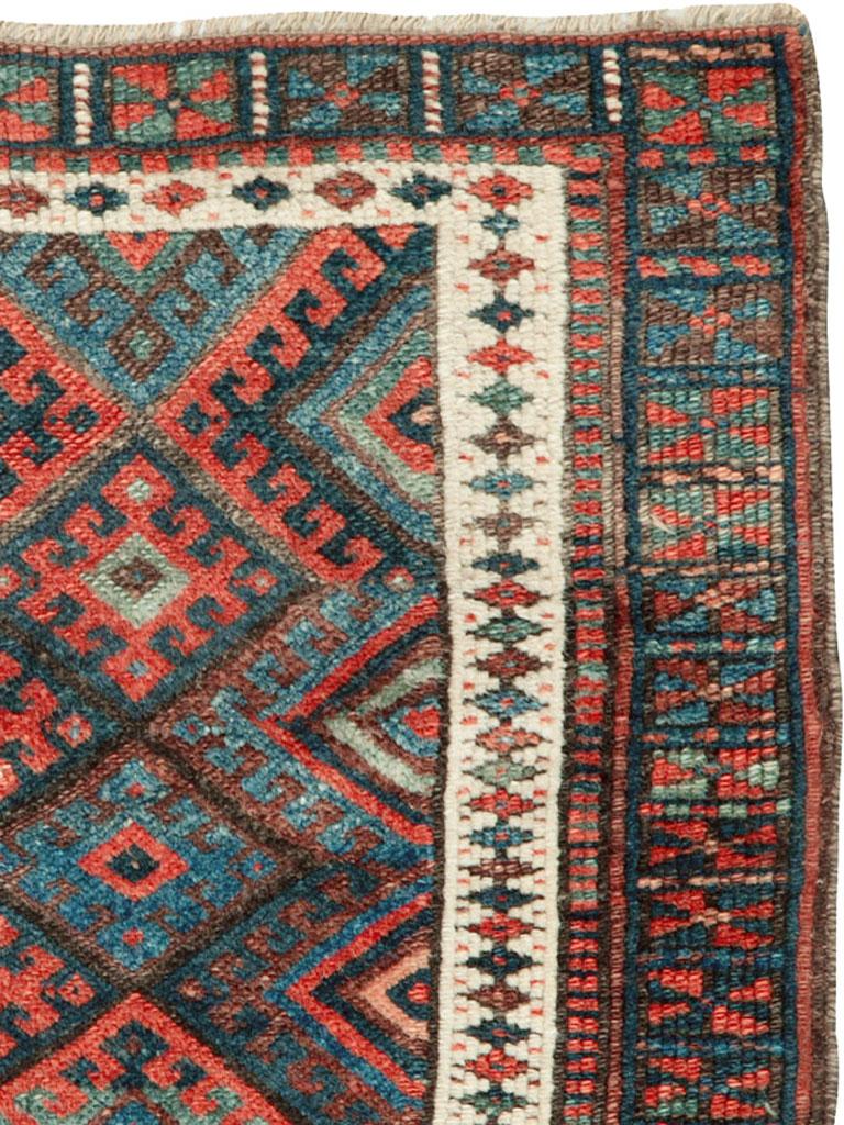 A handmade antique Persian Jaff Kurd rug from the early 20th century with a tribal design.