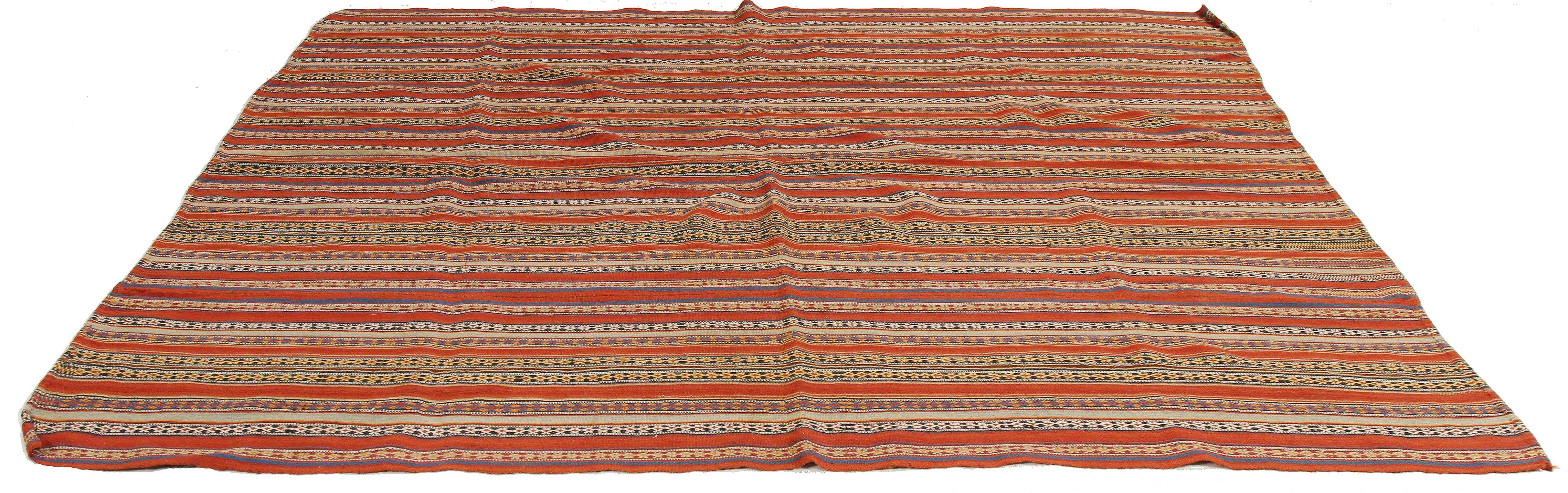 Antique Persian rug handwoven from the finest sheep’s wool and colored with all-natural vegetable dyes that are safe for humans and pets. It’s a traditional Jajim flat-weave design featuring a red and blue striped field adorned with tribal details.