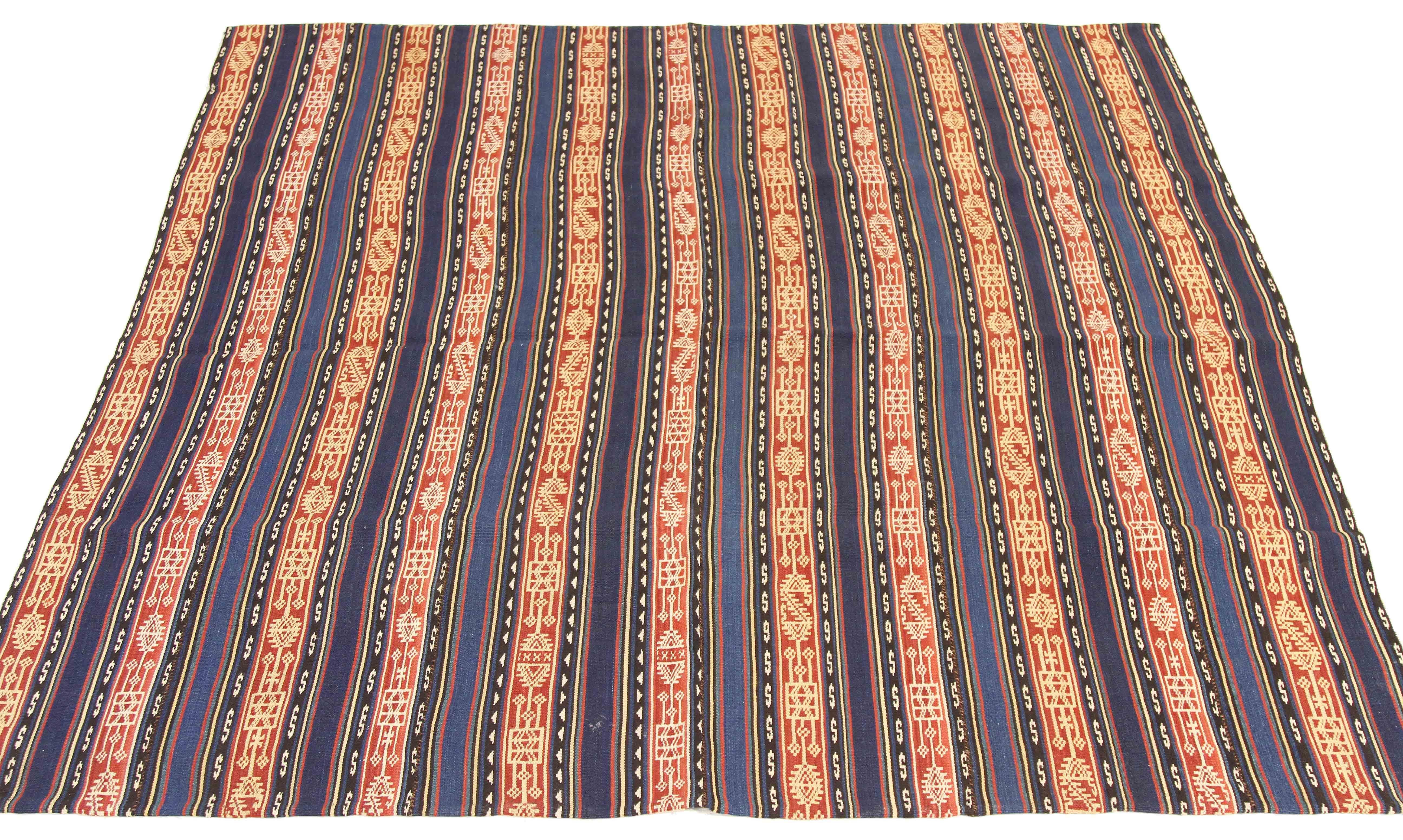 Antique Persian rug handwoven from the finest sheep’s wool and colored with all-natural vegetable dyes that are safe for humans and pets. It’s a traditional Jajim flat-weave design featuring navy and brown tribal stripes. It’s a stunning piece to