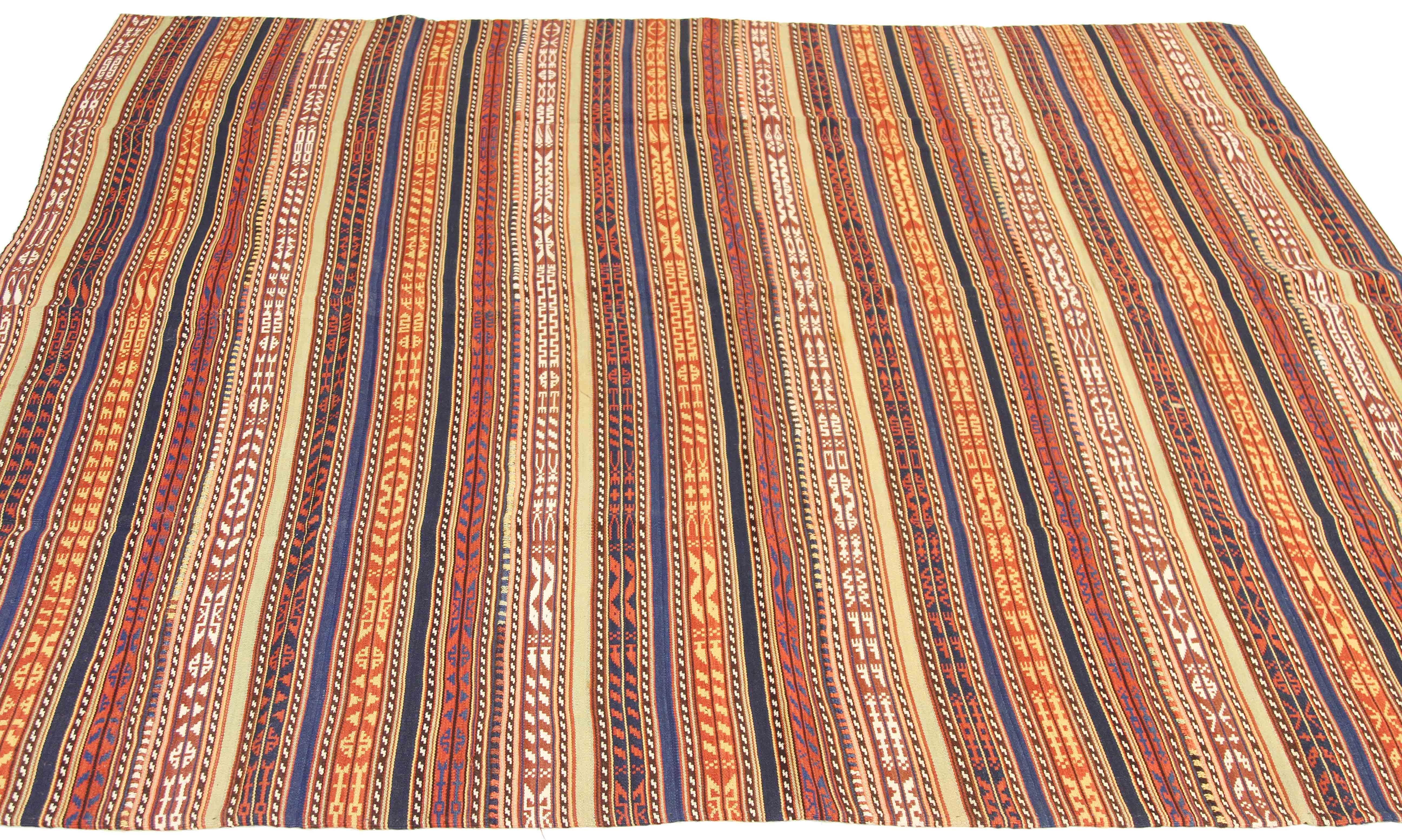 Antique Persian rug handwoven from the finest sheep’s wool and colored with all-natural vegetable dyes that are safe for humans and pets. It’s a traditional Jajim flat-weave design featuring red and blue tribal stripes. It’s a stunning piece to get