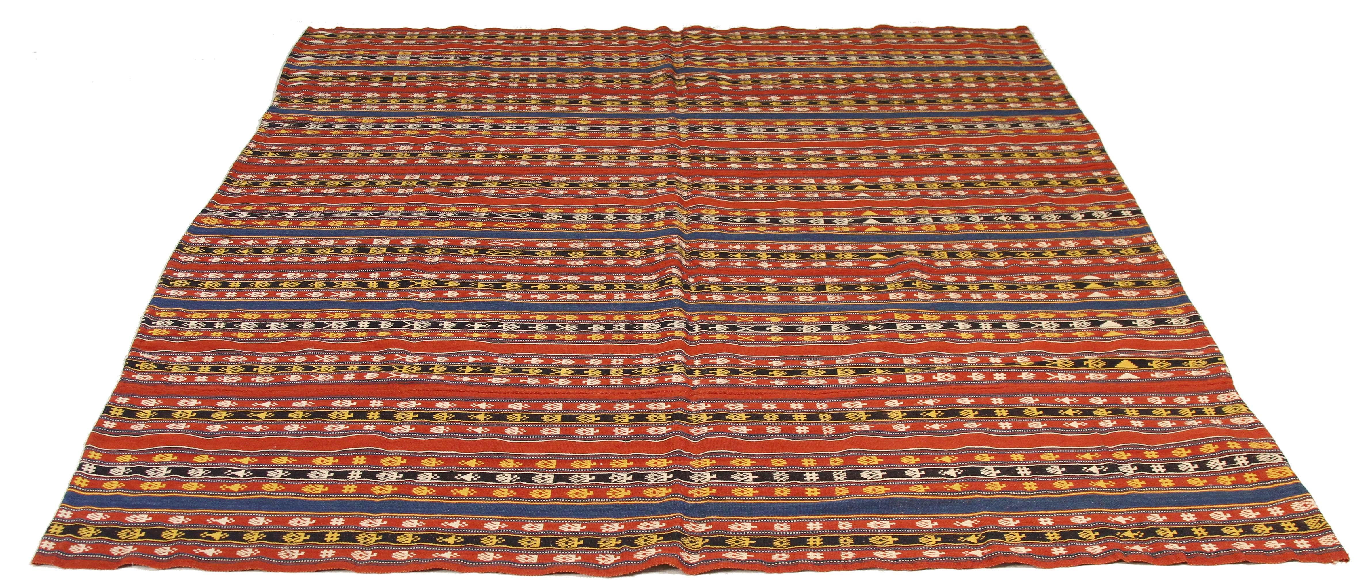 Antique Persian rug handwoven from the finest sheep’s wool and colored with all-natural vegetable dyes that are safe for humans and pets. It’s a traditional Jajim flat-weave design featuring white and gold geometric details on a red and blue striped