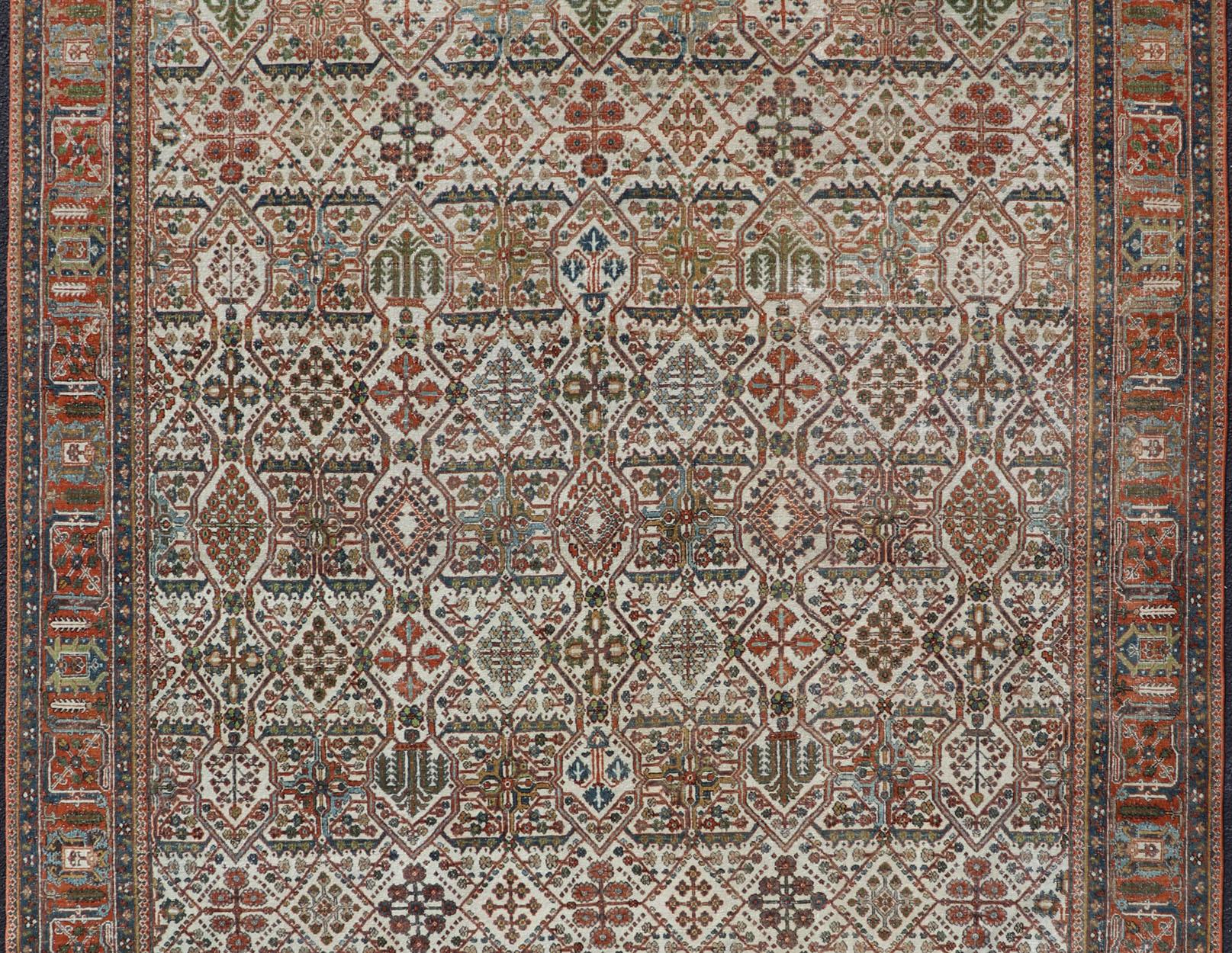 20th Century Antique Persian Joshegan Rug in Ivory Background With Blue, Green, & Copper  For Sale
