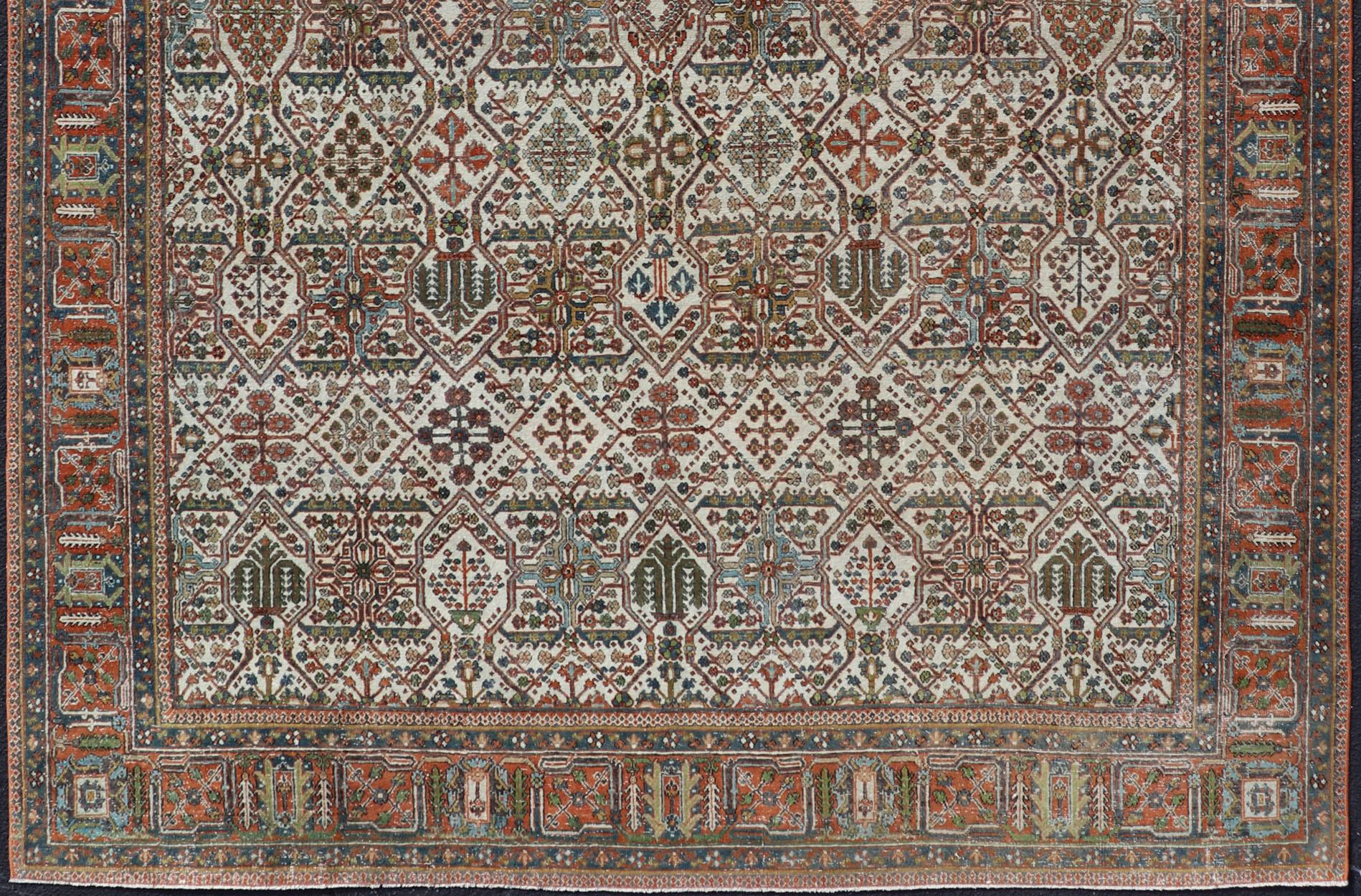 Wool Antique Persian Joshegan Rug in Ivory Background With Blue, Green, & Copper  For Sale
