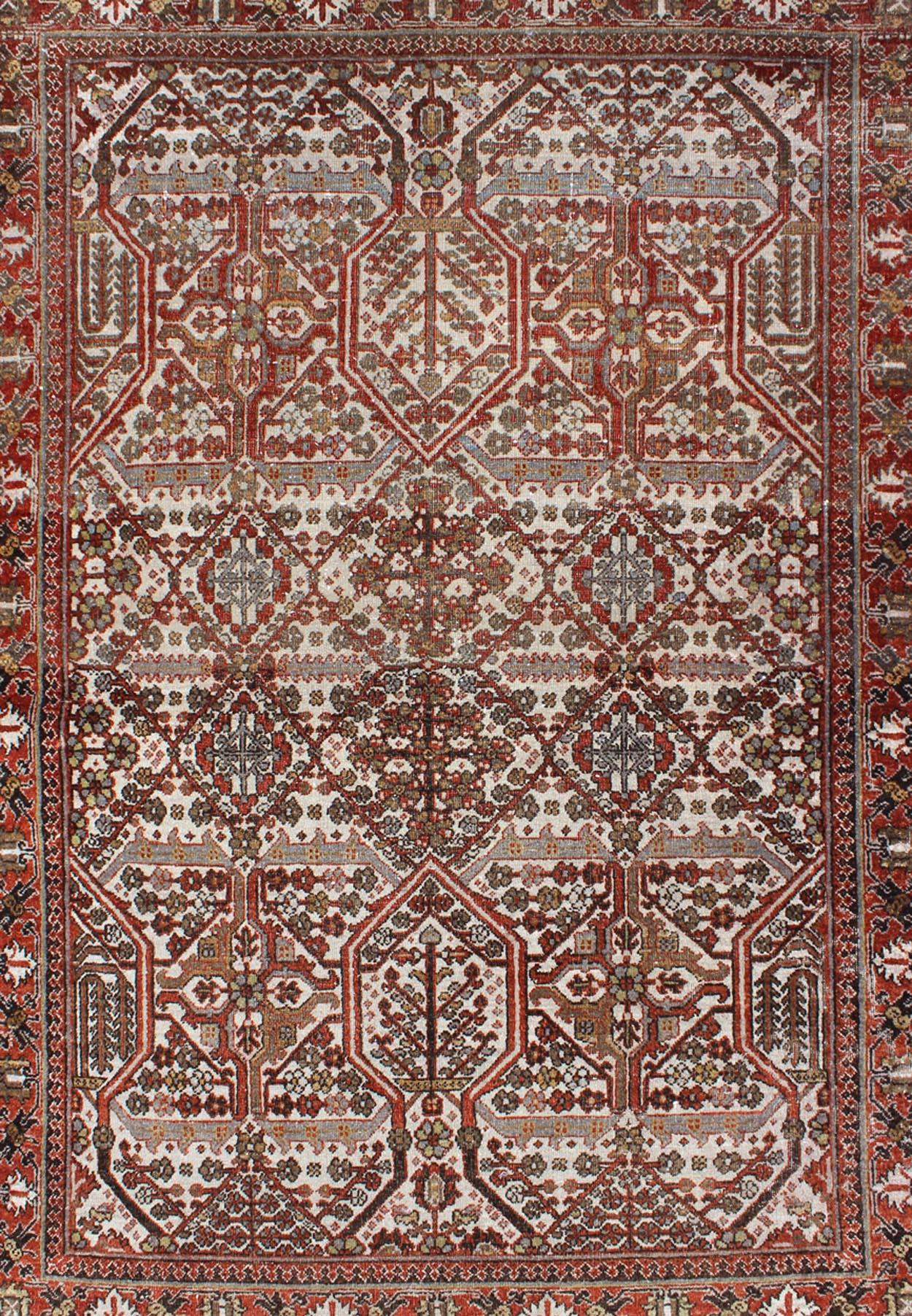 Antique Persian Joshegan Rug in Ivory Background with Red, Green and Blue 
This antique Joshegan rug from 1920s Iran was handwoven and bears a remarkably unique all-over interconnected Sub-geometric design, consisting mostly of diamond shapes and