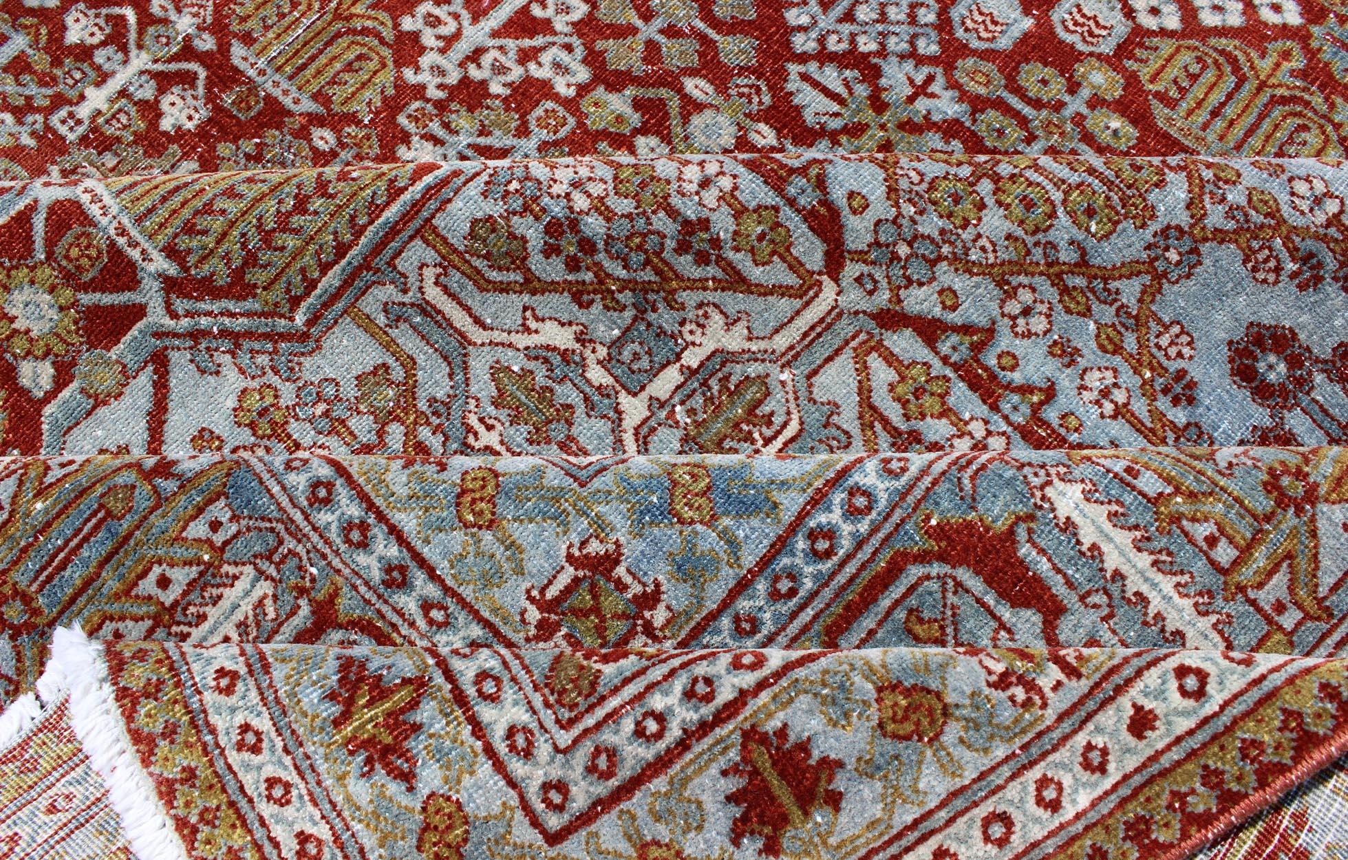 Large Antique Persian Joshegan rug with geometric medallion in rust red, light blue, green, gold and olive, rug 18-0101, country of origin / type: Iran / Joshegan, circa 1920.

Measures: 12' x 20'.

This finely woven antique Persian Joshegan rug