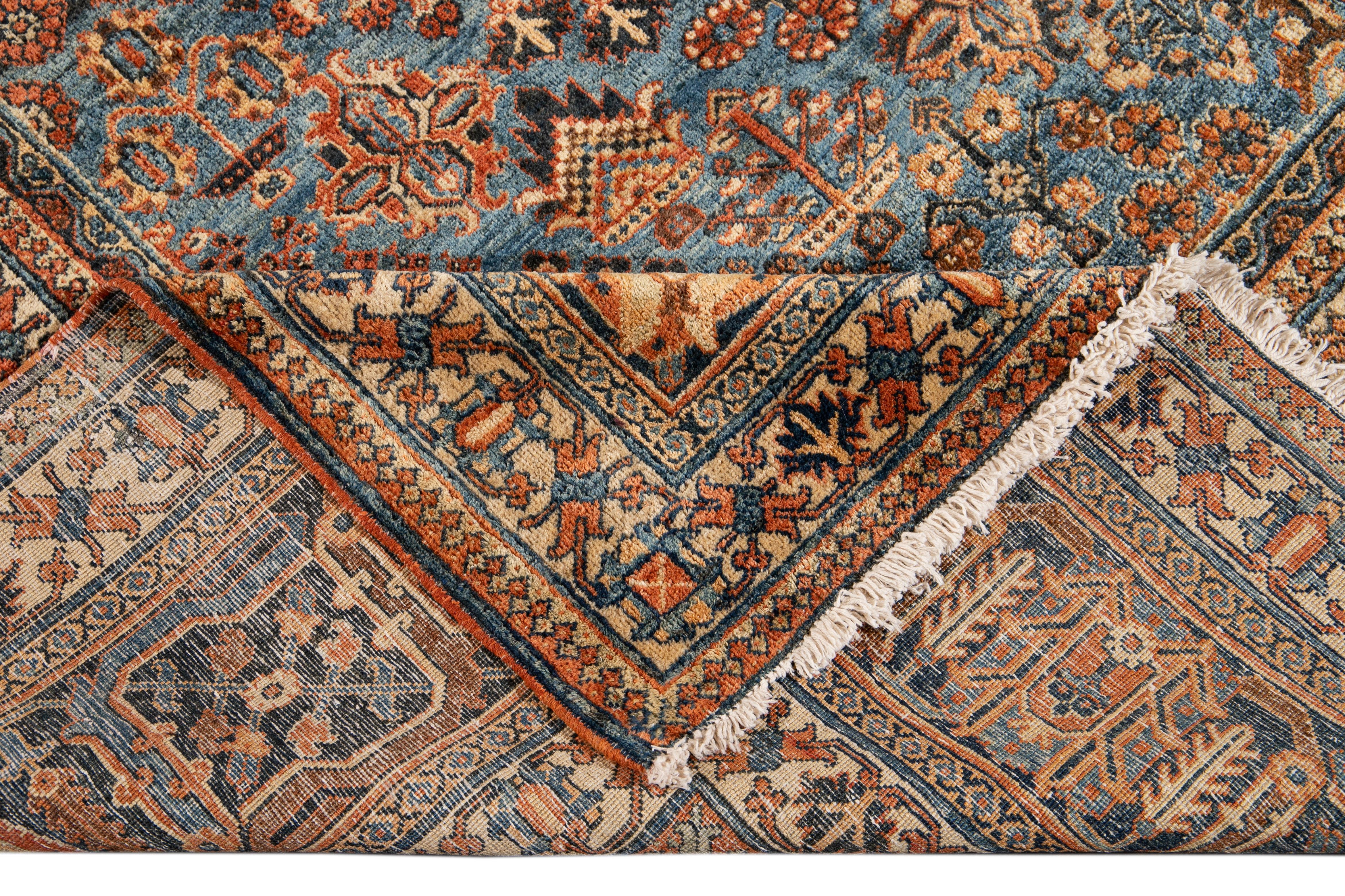 Beautiful antique Josheghan hand-knotted wool rug with an orange-rust field. This Persian rug has multi-color accents in a gorgeous all-over medallion floral design.

This rug measures: 13'7