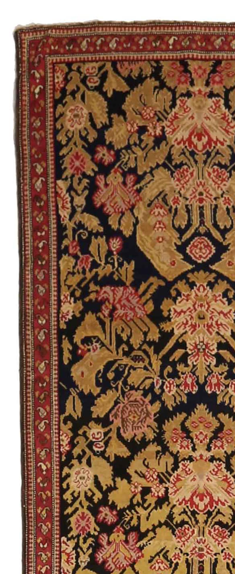 Antique Persian rug handwoven from the finest sheep’s wool and colored with all-natural vegetable dyes that are safe for humans and pets. It’s a traditional Karabagh design featuring a deep black field covered with red, ivory and golden floral