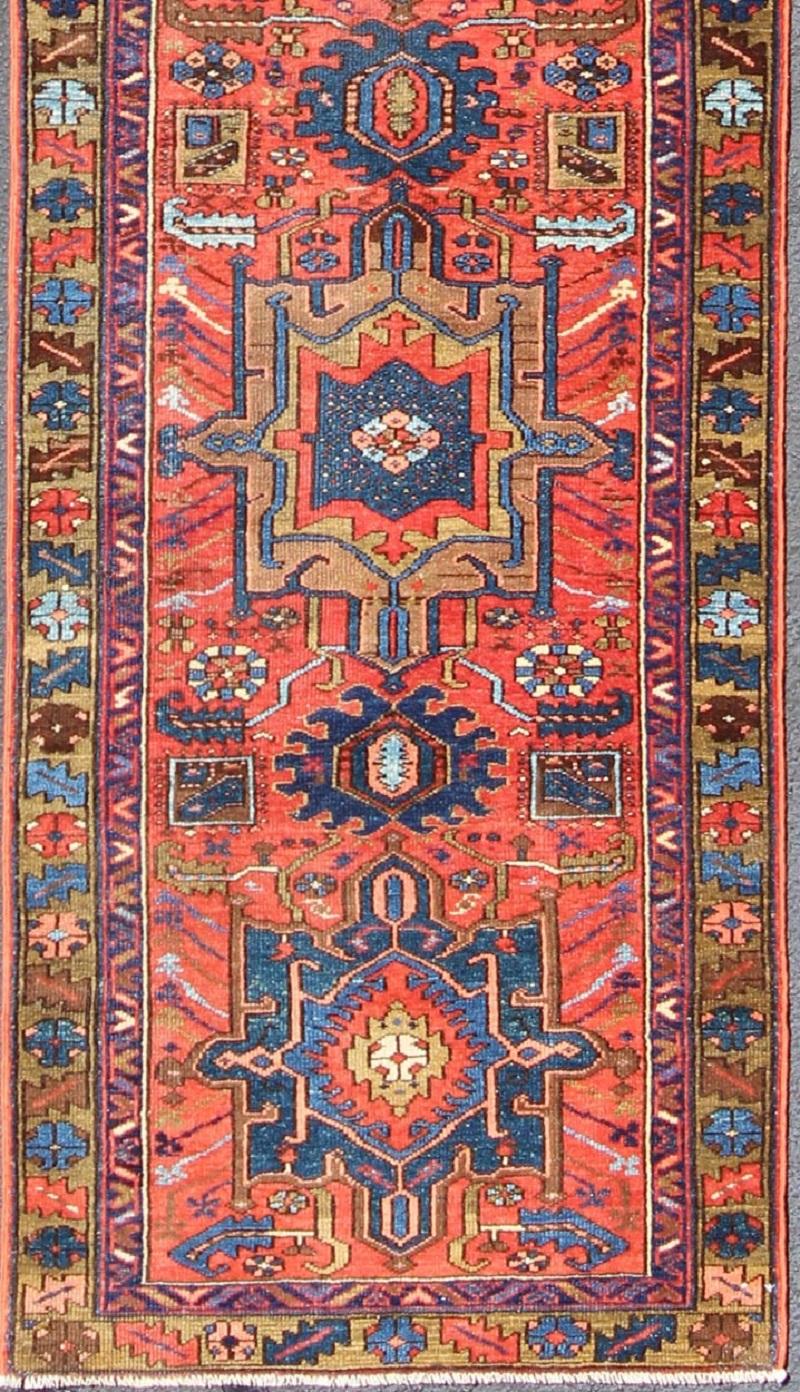 Geometric layered medallion design antique Karadjeh runner from Persia with red-orange and blue colors, rug gng-4773, country of origin / type: Iran / Karadjeh, circa 1920

This early 20th century, handwoven antique Persian Karadjeh runner